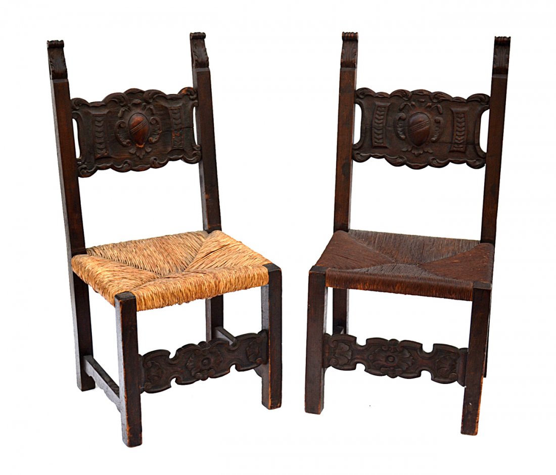Pair of 19th Century Side Chairs: Renaissance Revival-style side chairs having carved oak frames with rush seats on block legs.