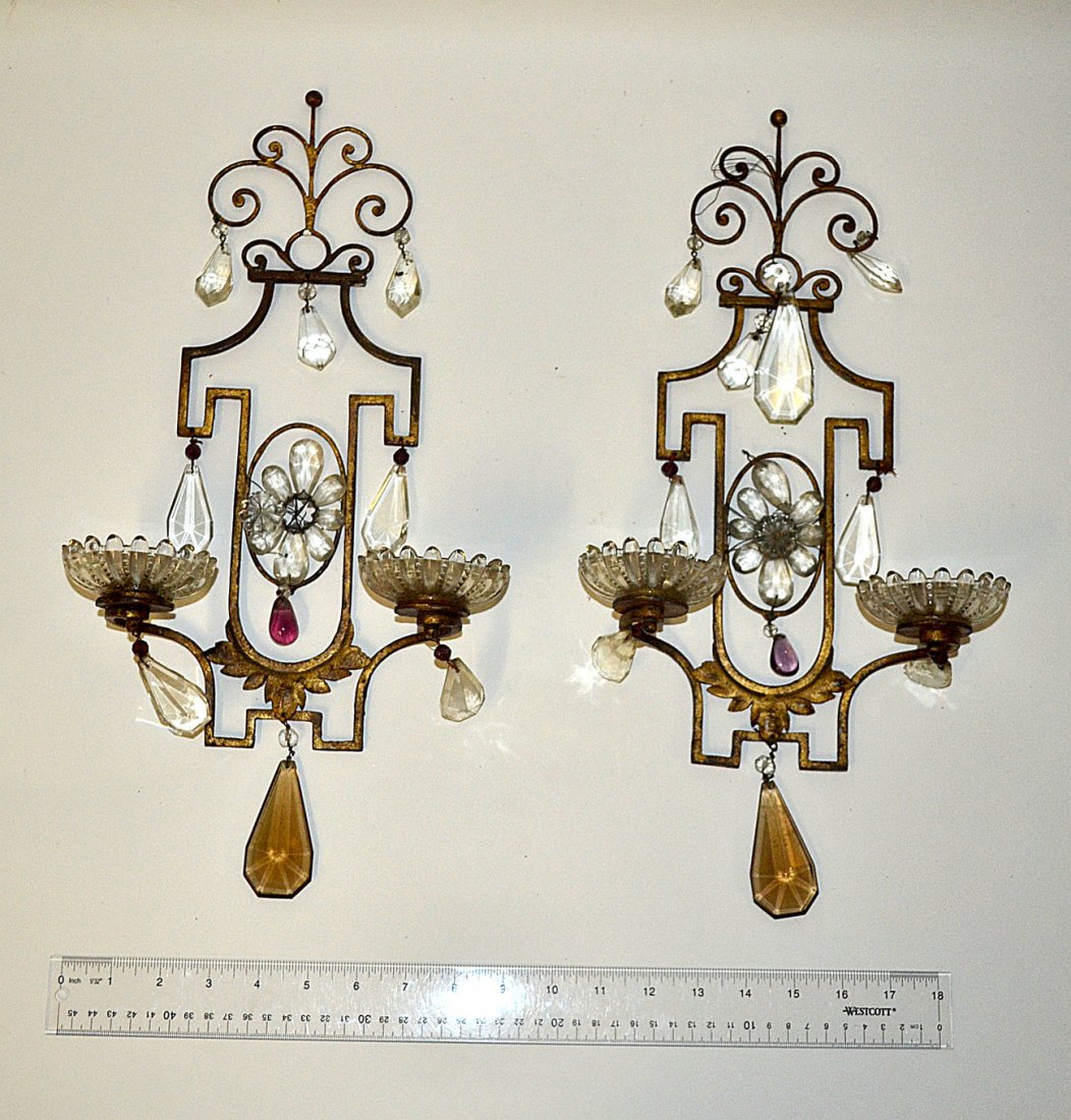 Pair of Louis XV Style Gilt Sconces: Patinated gilt metal sconces having scroll and leaf motifs with faceted crystal drops.