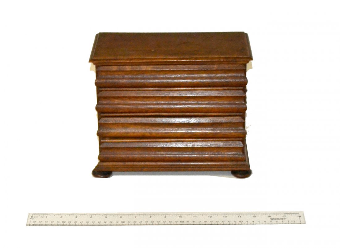 Biedermeier Miniature Chest: Biedermeier miniature chest on bun feet, lined with period paper. Refinished condition.