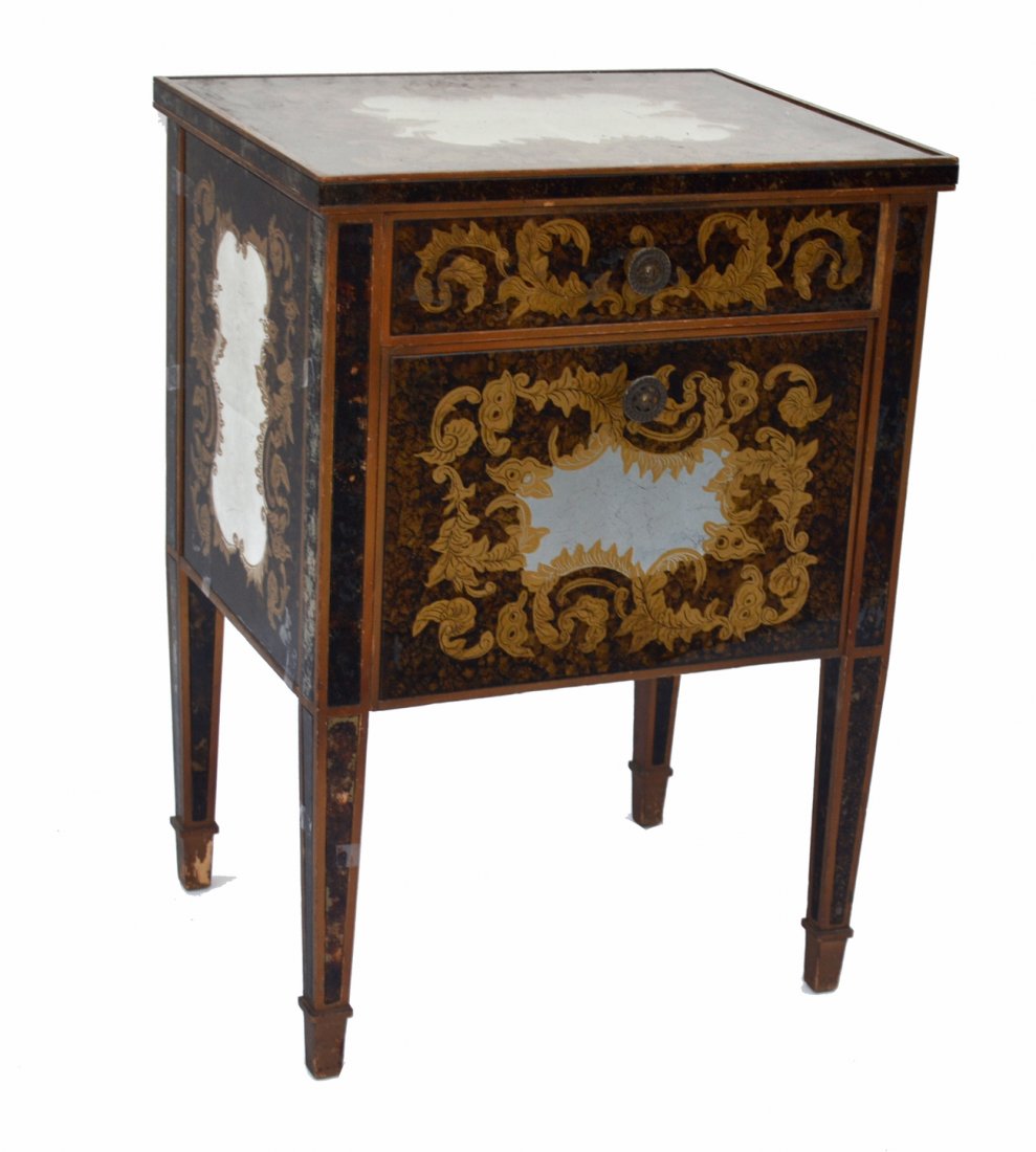 Italin Mid Century Verre Eglomise Side Table: Features reverse painted glass panels with mottled backgrounds and leafy gold cartouche elements with silver leaf reserves. Bears one drawer above a fall front door. [20"W x 16"D x 28"H]