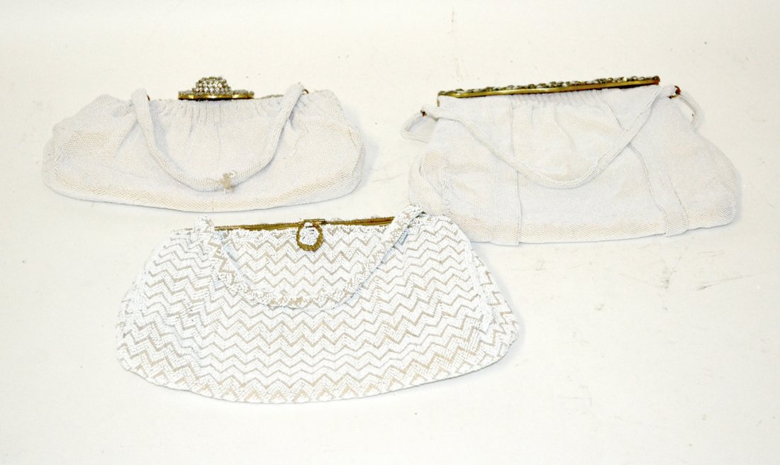 Three French Mid-Century Beaded Evening Bags: Micro-glass beaded handbags comprising: 1.) Double handle bag with bronze fittings and spring hinged clasp bearing clear and smoked paste stones. 2.) White and tan beaded bag with zig-zag pattern. 3.)