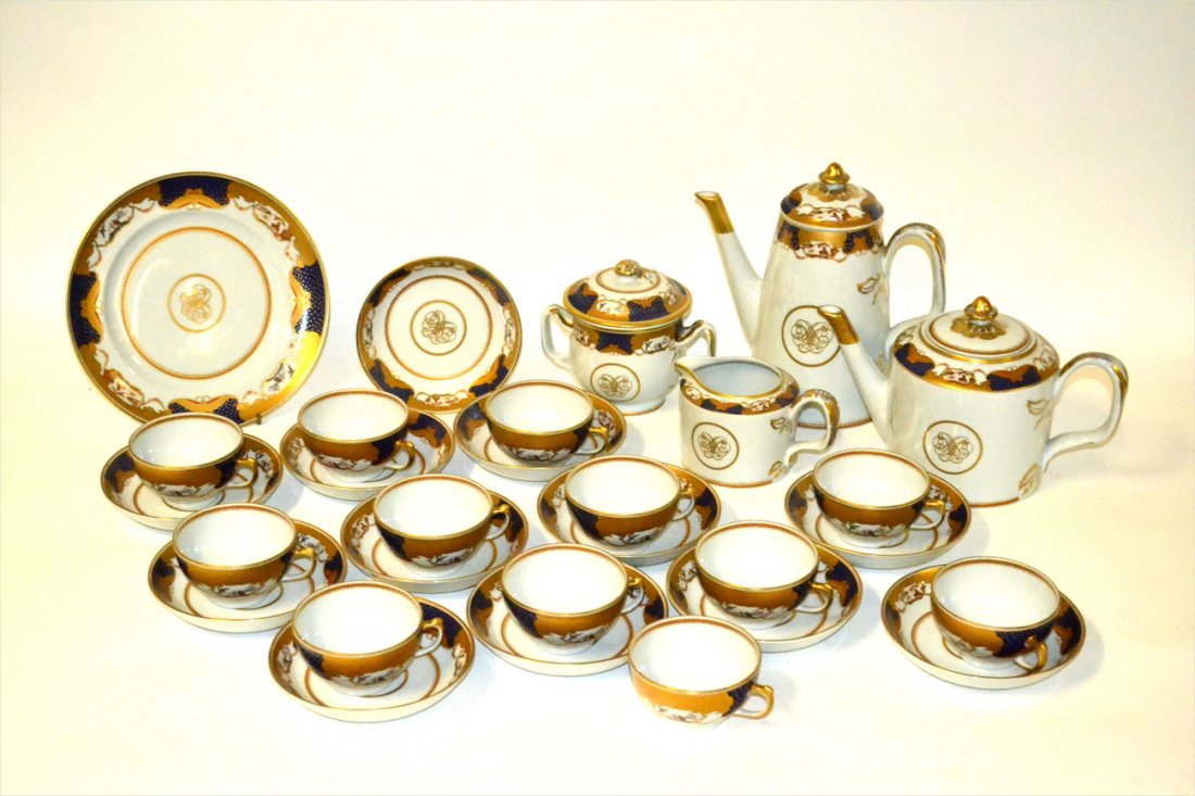 Mottahedeh Dessert Service (40pcs.): Blue and gold with butterflies and birds as decoration. 40 pieces total including covered teapots, covered sugar bowl and a creamer.