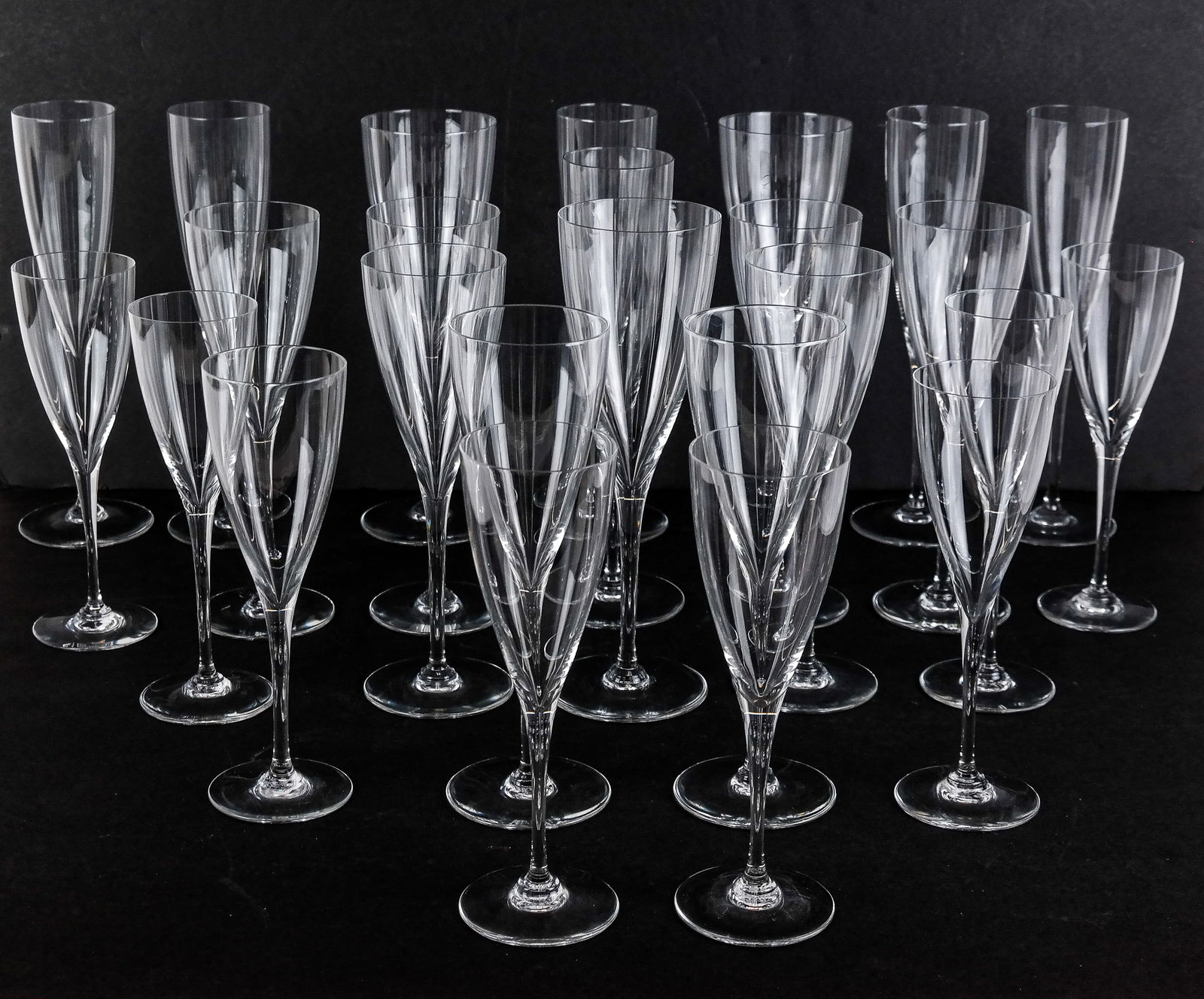 Baccarat "Dom Perignon" Crystal Glassware, 24: Baccarat "Dom Perignon" crystal stemware, comprising 6 champagne flutes [9.25" H], 3 water goblets [9" H], 8 port wine glass [7.25" H],and 7 claret wine glasses [8.25" H] , marks to bases. Overall con