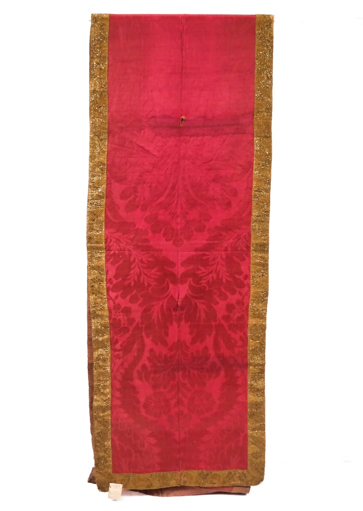 18th/19th C. Brocatelle Runner: An 18th/19th Century runner having a full selvage width of berry pink brocatelle with large scale florals and wide gold ribbon trim, unlined. [140.5" L x 24" W]. Large areas of loss at the center, sta