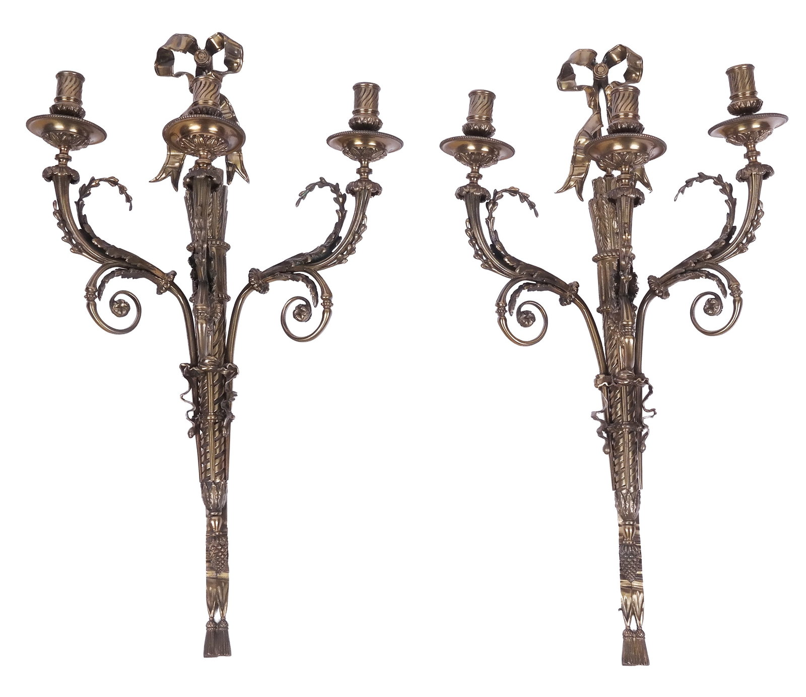 Pair of Louis XVI Bronze Sconces: Pair of Louix XVI bronze sconces, 19th century, with a ribbon to upper over a decorated stem with three girandole arms. [28" H x 16.5" W x 9" D]. Condition to each is good with some minor blemishes.