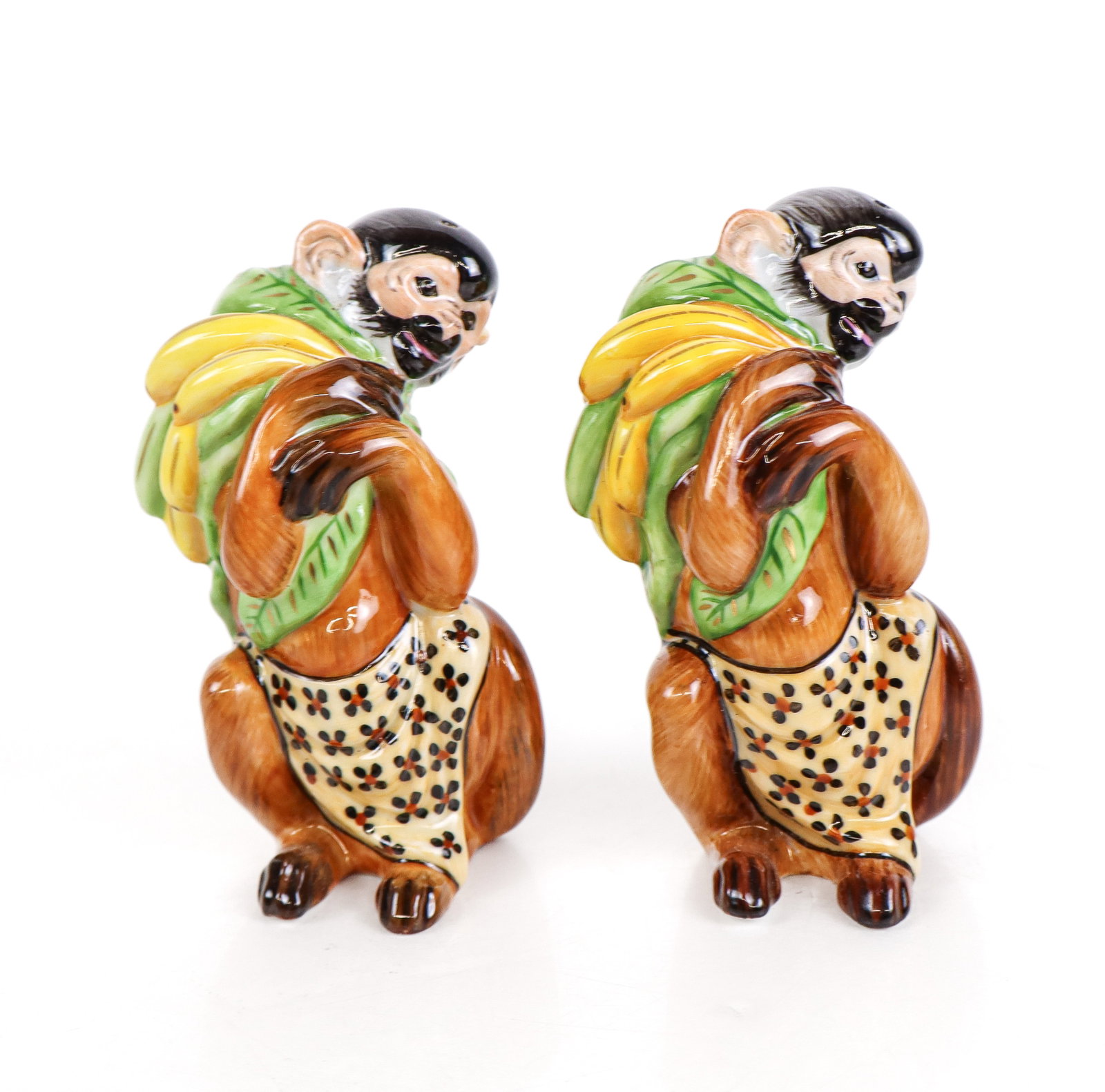 Lynn Chase Hollohaza Monkey Shakers: Lynn Chase for Hollohaza Hungary hand-painted porcelain monkey shakers, marked Hollohaza to base of each. [4.5" H x 2" W x 2.25" D]. Condition is good.