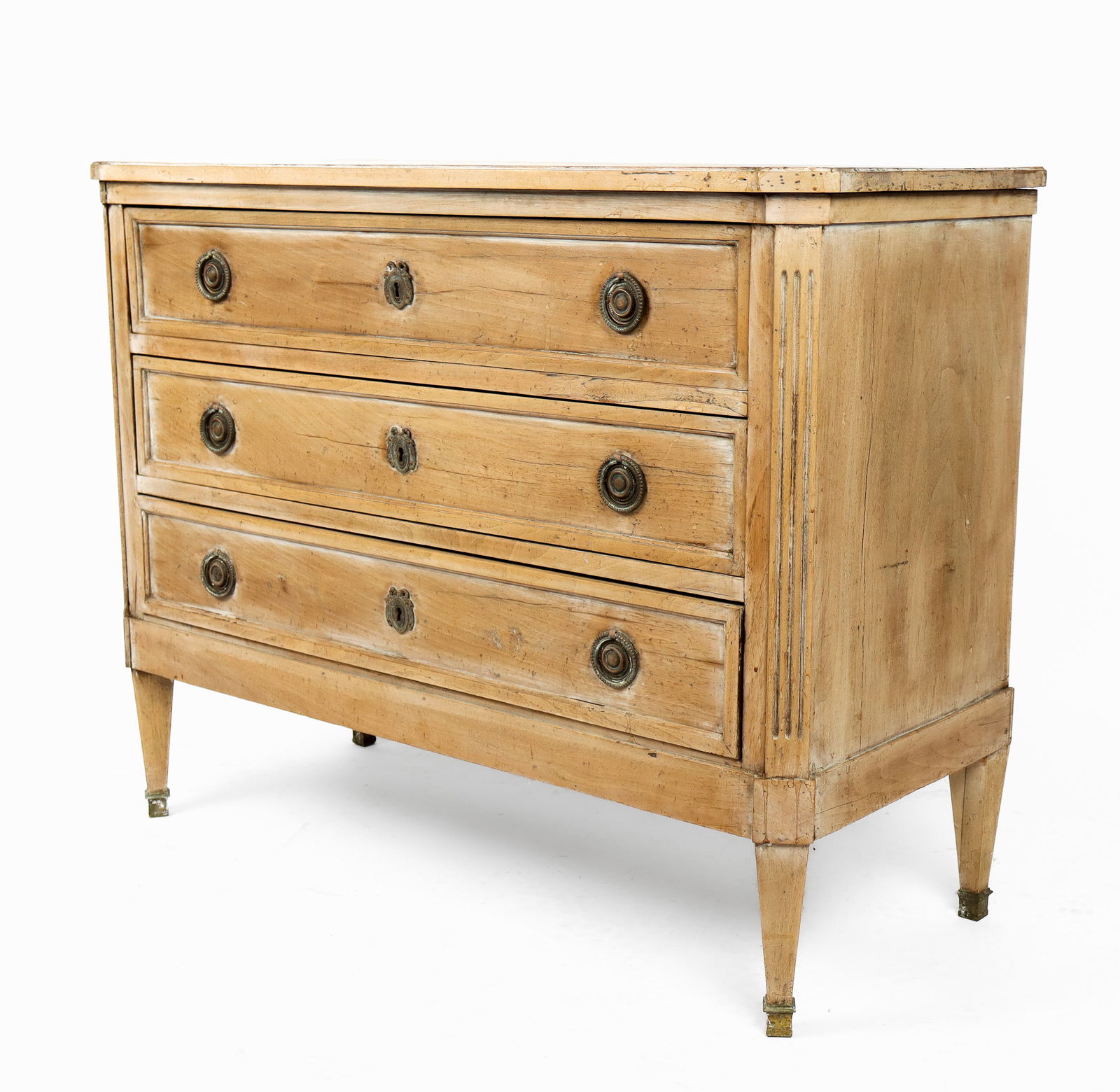 Louis XVI Three-Drawer Beechwood Commode: Louis XVI three-drawer beechwood commode, 20th century, with three brass mounted drawers and tapered legs, key present. [32" H x 41" W x 17" D]. Condition is good with areas of discoloration to upper.