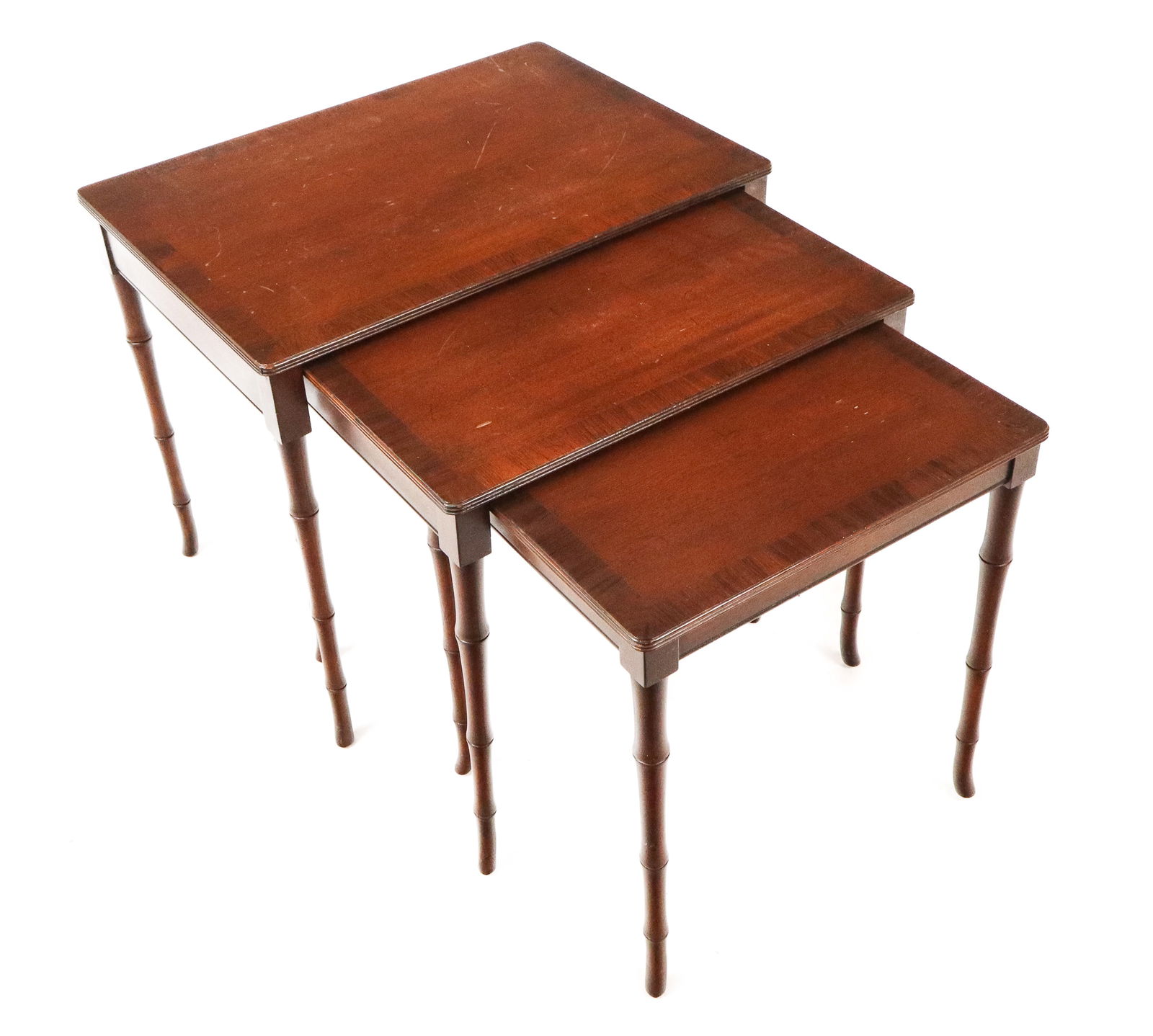 Fine Arts Furniture Mahogany Nesting Tables, 3: Three Fine Arts Furniture mahogany nesting tables, 20th century, with carved faux bamboo legs, marked Fine Arts Furniture, Grand Rapids to underside. [Largest table: 20" H x 22" W x 16" D]. Condition