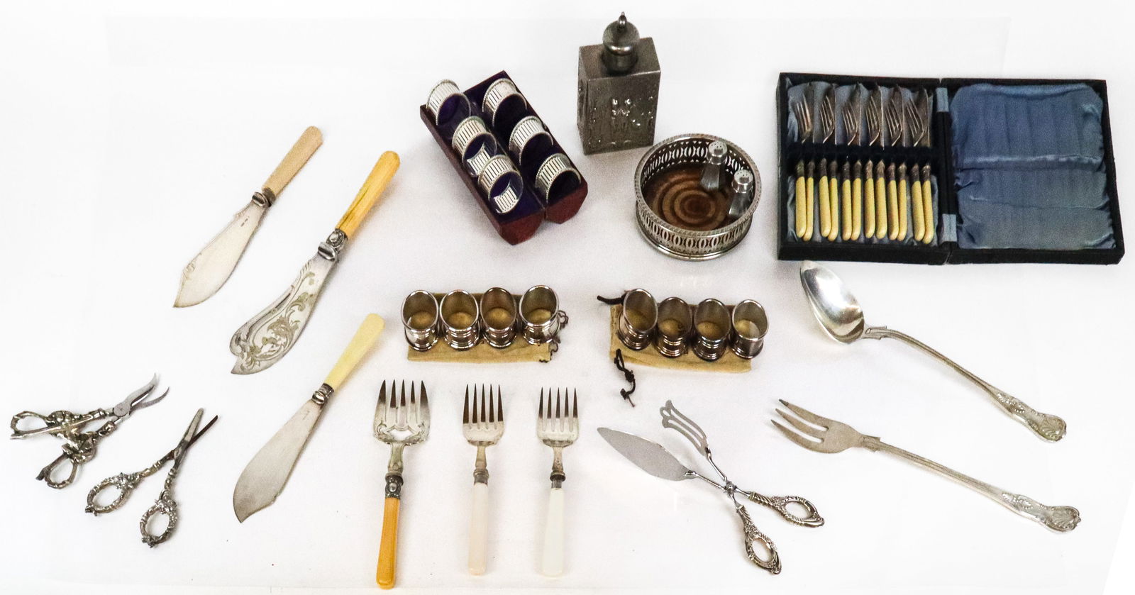 Group of Silver Plate, Pewter & Metal Tablewares,: Group of assorted silvered items, comprising pair of French pewter salt and pepper shakers, wine coaster, cannister, box set of silver plated napkin rings, 8 Lappas Argentina napkin rings, and assorte