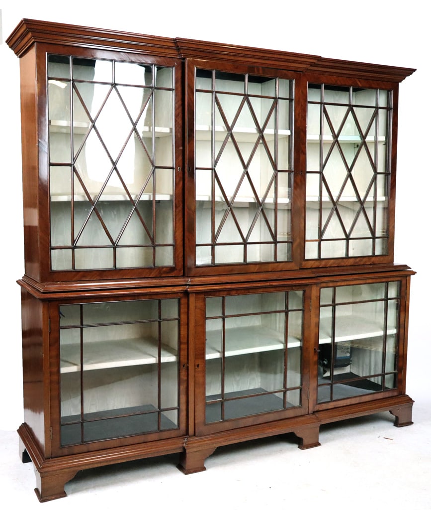 Regency Mahogany Breakfront Display Cabinet: Regency mahogany breakfront display cabinet, late 19th century, with double casement, lattice windows, and moired silk to interior shelves. [78.5" H x 77" W X 18.5" D]. Condition is good with losses t