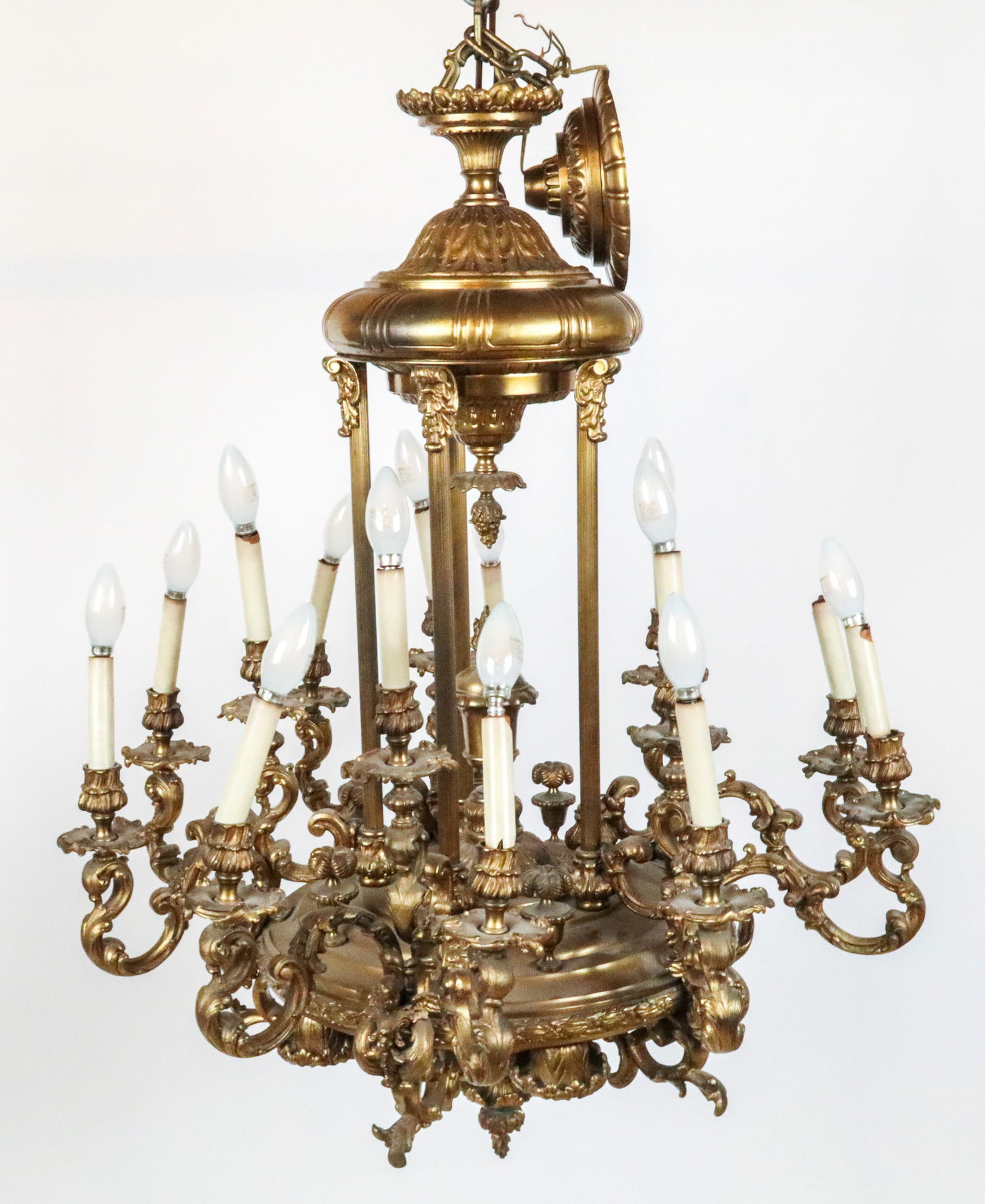 Napoleon III Gilt Metal Chandelier: Napoleon III gilt metal fifteen light chandelier, 20th century, accented with winged putti, acanthus leaves and foliate scrolls. [36" H x 30" Diameter]. Overall condition is fair, one arm broken, one