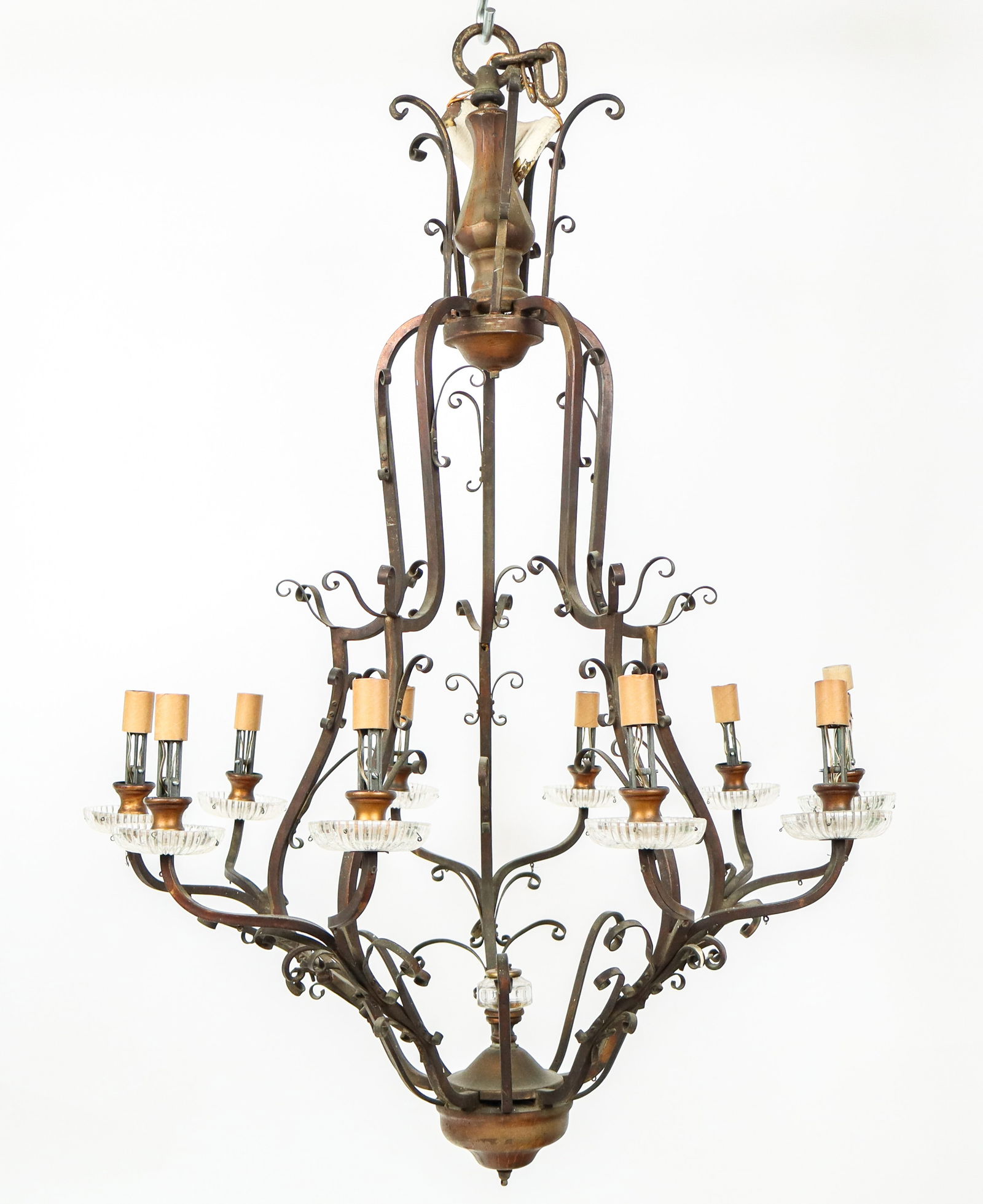 Wrought Metal and Crystal Chandelier: Wrought metal ten light skeletal chandelier with glass bobeches, 20th Century. [45" H x 32" Diameter]. Overall condition is fair/poor, parts deficient, wear.