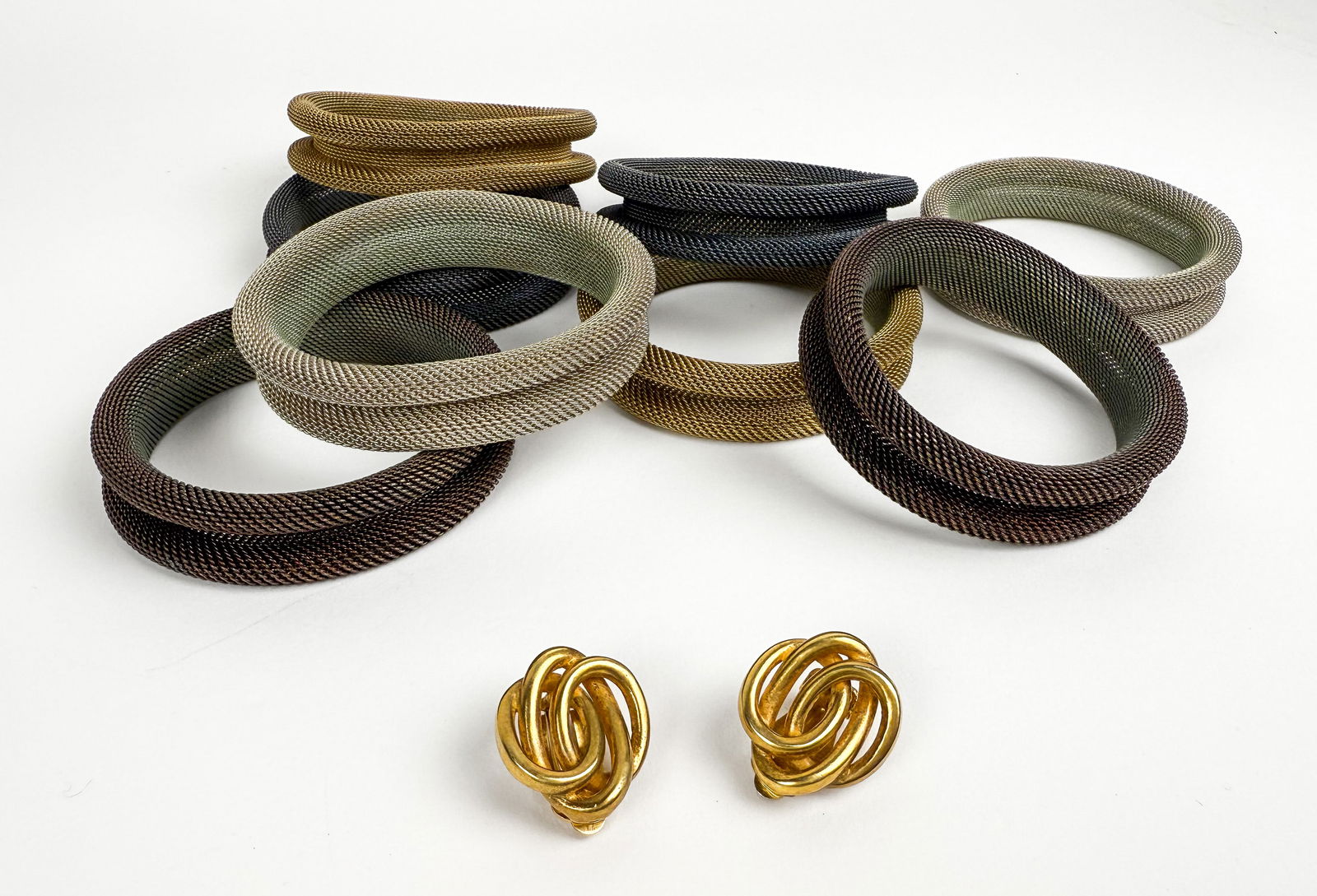 Erica Zap Collection of Mesh Bracelets: Erica Zap collection of mesh bracelets, comprising four pairs in various tones of silver, gold, black and brown; together with a pair of gold-tone ear clips, possibly Robert Lee Morris. [Bracelet: 7.5