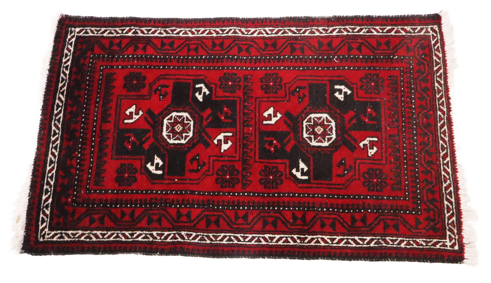 Oriental Rug: Oriental rug in red, black and white, in geometric designs. [3' (36") x 4'10" (58")]. In good condition.