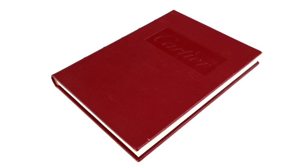 Cartier, by Hans Nadelhoffer, Red Leather Presenta: Cartier Jewelers Extraordinary, by Han Nadelhoffer, in a red leather presentation style book. Published by Harry Abrams. [12.25" H x 9.25" W x 1.25" D"]. Overall condition is good, front pages of 1st