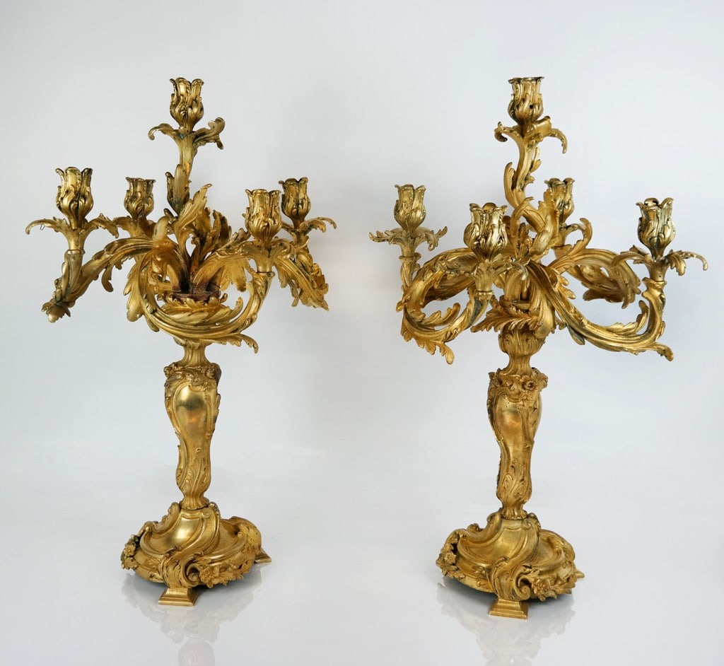 Pair of Rococo Gilt Bronze Candelabra: Pair of Rococo gilt bronze six light candelabra, 19h century, elaborately decorated with scrolling and foliate motifs accented with flower buds. [26" H x 17.5" Diameter]. Overall condition is