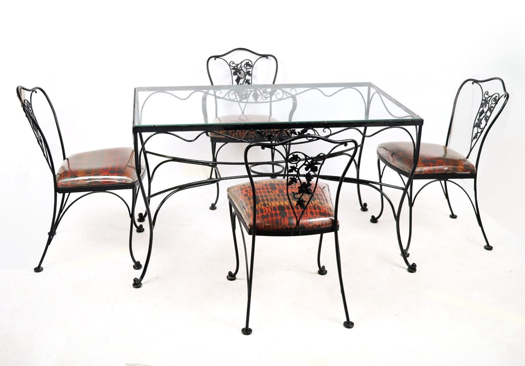 Iron and Grape Decorated Outdoor Dining Set, 5: Iron and grape decorated five-piece dining set, 20th century, comprising a glass top table with grape-decorated apron, and four cabriole legs joined by a cross-stretcher, accompanied by an arm chair a