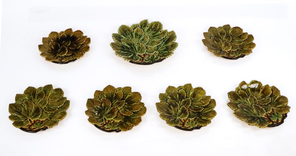 Grape Leaf Decorated Majolica Plates, 7: Seven majolica plates in the form of grape leaves, Czech, 20th century, comprising six salad plates and one dinner plate, each marked Czechoslovakia to base. [Largest: 10" Diameter]. Condition is