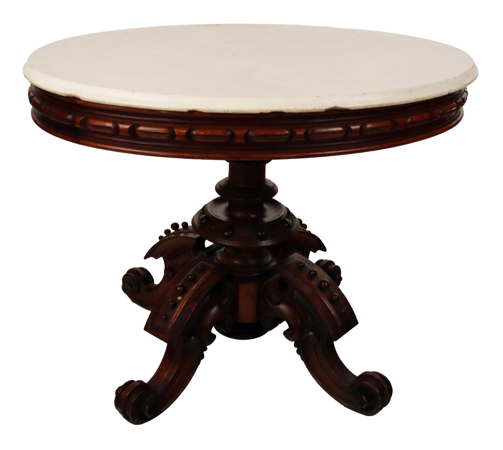 Victorian Marble Top Center Table: Victorian marble top center table, 19th century with beveled marble top, carved apron, and a heavily carved and mounted and ball beaded and four-scroll legged base. [29" H x 28" W x 39" D]. Condition