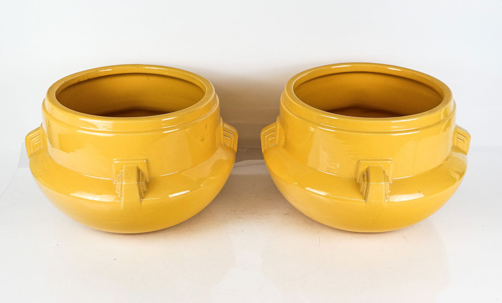 Pair of Mid-Century Modern Jardinieres: Pair of Mid-Century Modern porcelain jardinieres, mid-20th century, with decoration to sides, unmarked. [10" H x 15" Diameter]. Condition to each is good. From the Collection of Sonia and Philip Reine