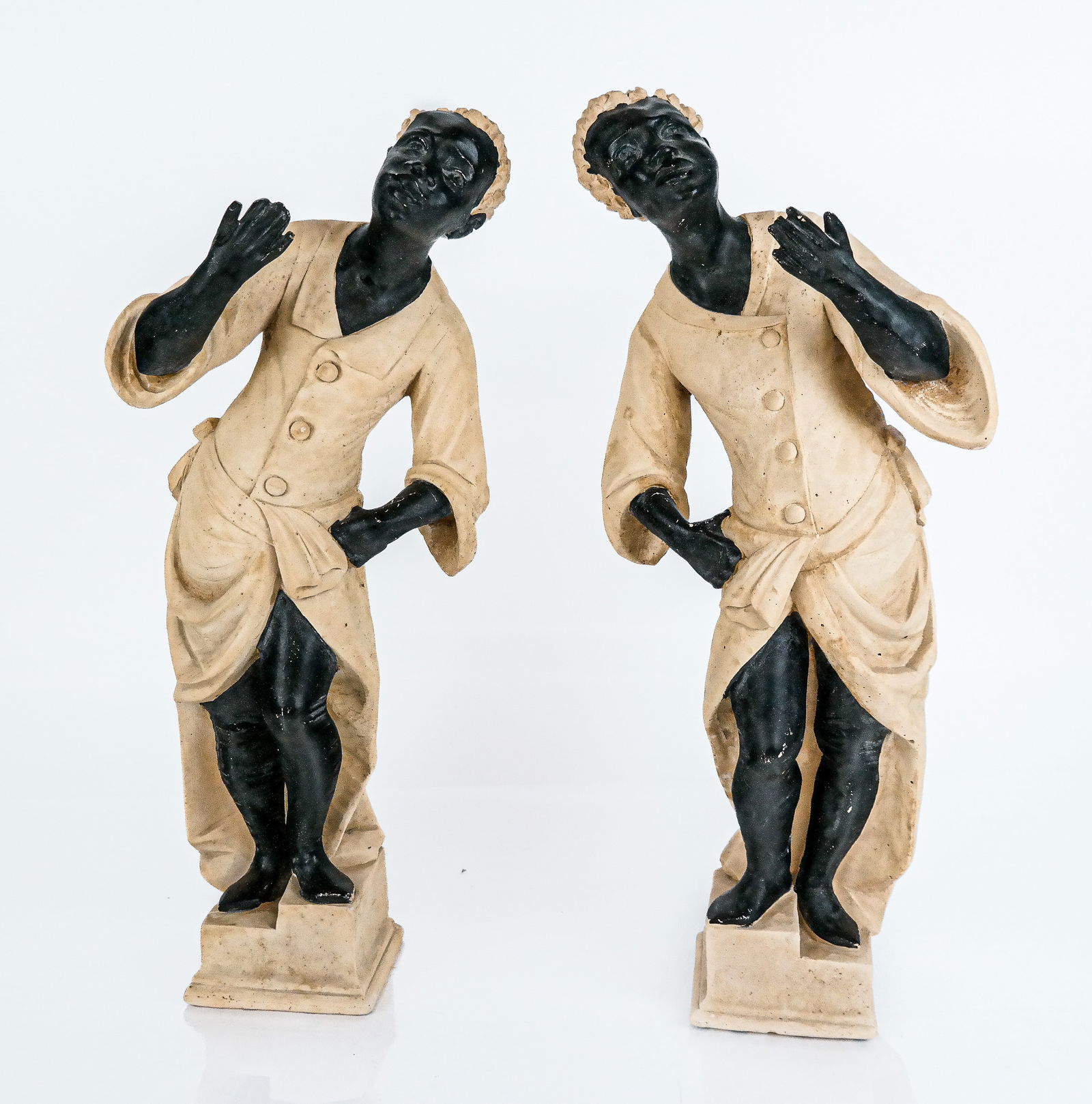 Complimentary Pair of Blackamoor Figures: Complimentary pair of blackamoor figures, 20th century, made from composite, with affixed bases, unsigned. [18" H x 7.5" W x 4" D]. Condition to each is good with some minor wear. From the Collection