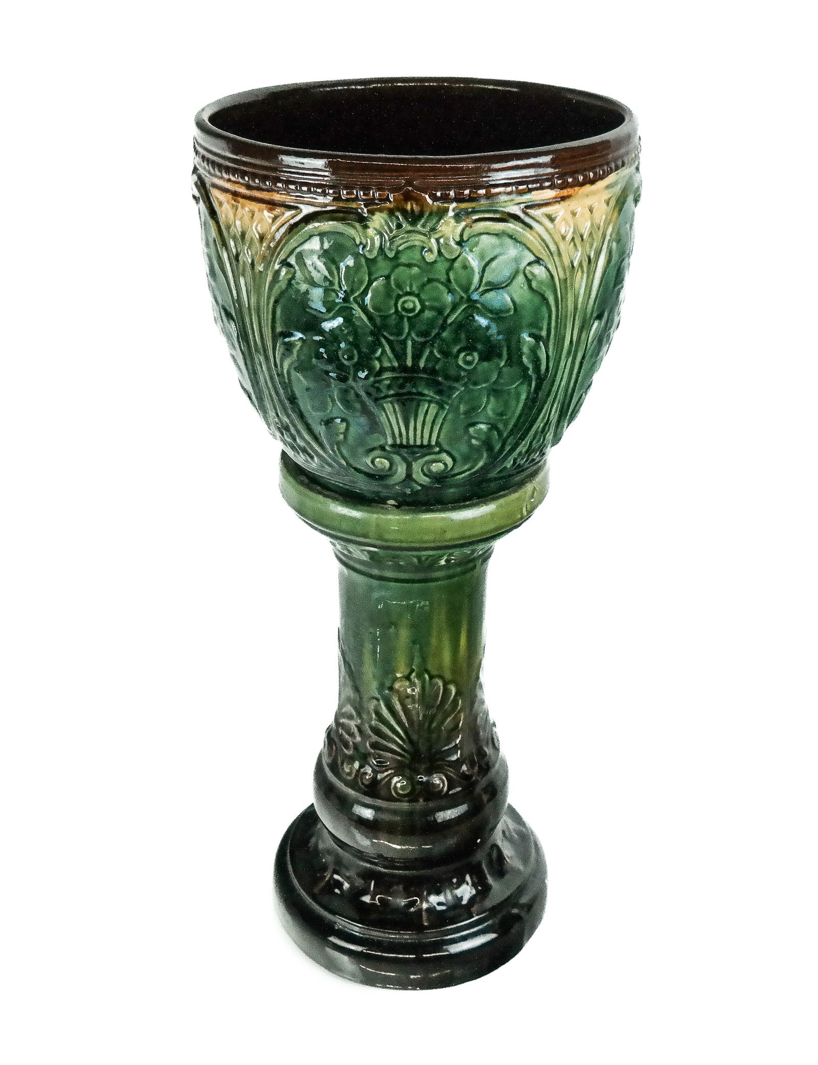 Majolica Porcelain Jardiniere on Stand: Majolica porcelain jardiniere on stand, likely American 20th century, with impressed bouquet cartouches to upper and decoration to lower, unmarked. [25" H x 11.25" Diameter]. Condition is good with so