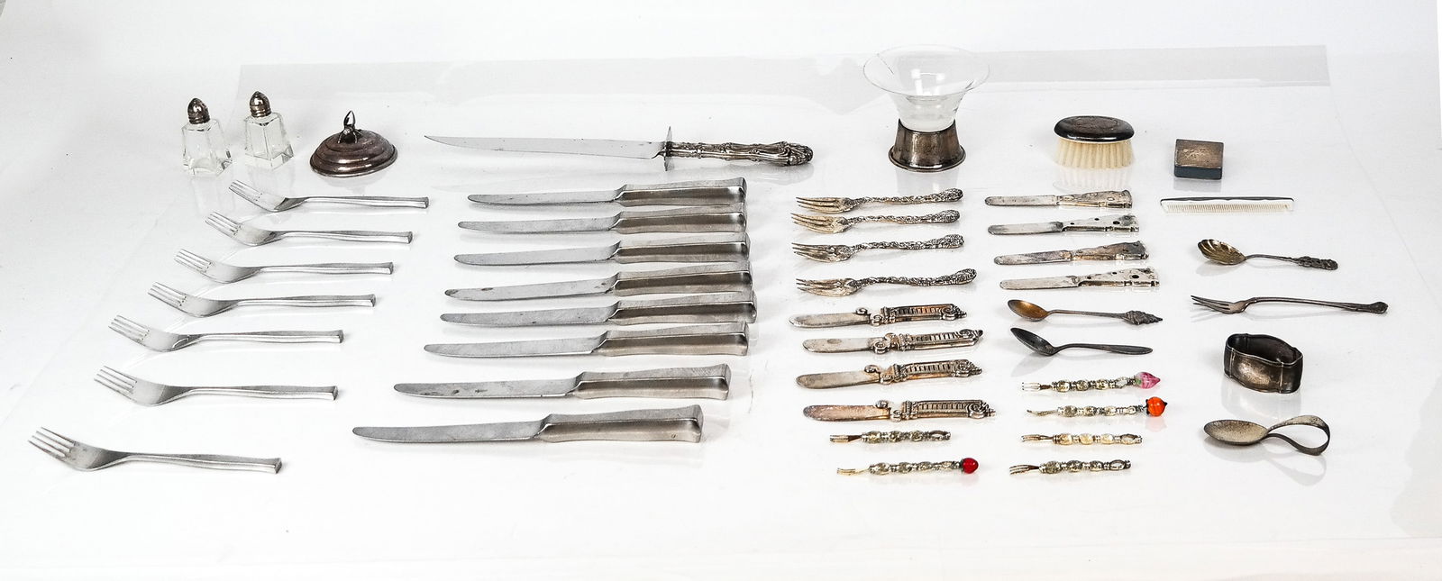 Collection of Silver, Plate and Metal: Collection of silver, plate and metal, comprising Supreme Cutlery stainless steel flatware - 7 forks and 8 knives, Allan Adler sterling silver and glass candlestick, Amston Silver Co. sterling silver