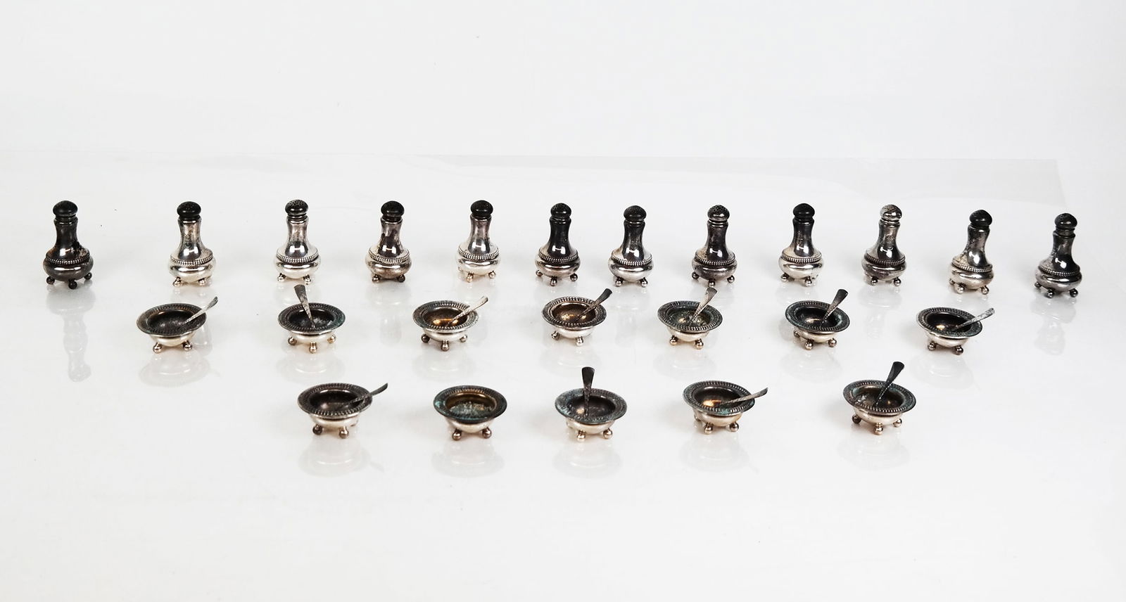 Gorham Sterling Salt, Spoon & Pepper Shakers, 35: Gorham sterling silver individual salt cellars, spoons and pepper shakers, marks to reverse. [Total 15 ozt., Salts: 2" Diameter, and Peppers: 2.5" H]. Overall condition is good/fair, most with