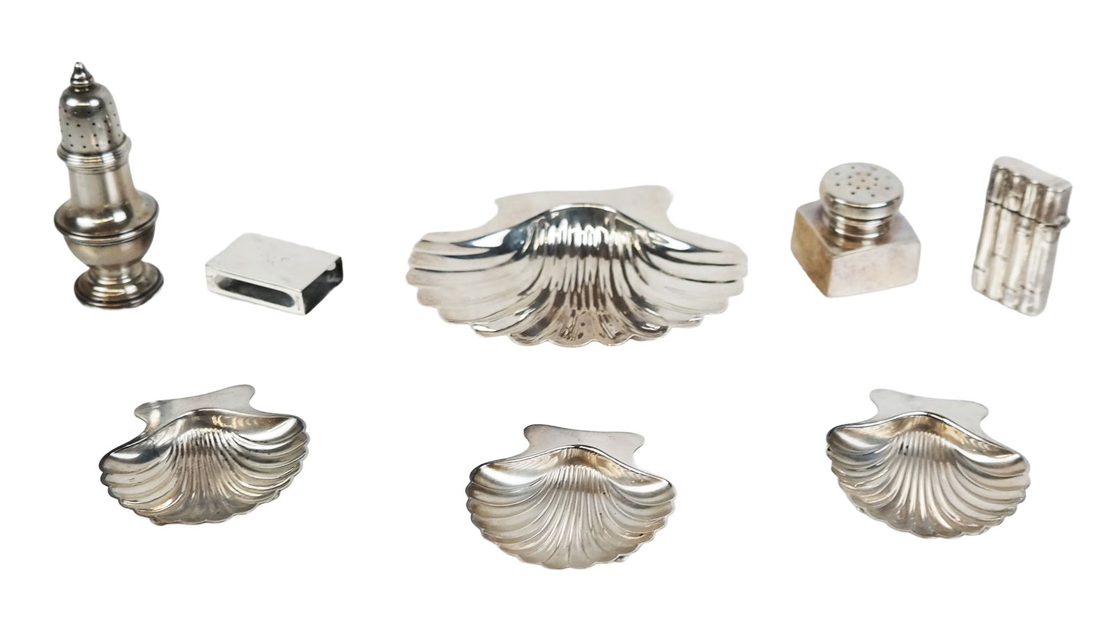 Tiffany & Co. Makers Et Al Sterling Table Articles: Tiffany & Co. Makers and others collection of sterling silver, comprising 3 Tiffany & Co. Makers shell form ashtrays, shell form ashtray, salt shaker, Cartier match box cover, Tiffany & Co. match