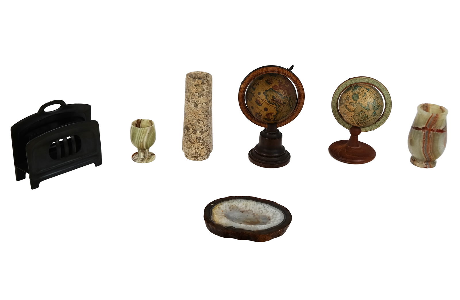 Assorted Desk Articles, 7: Assorted desk articles, 20th century, comprising a Kronheim and Oldenbusch bronze Art Deco bill holder, a green onyx bud vase, a green onyx cordial, a fossil stone vase, an agate dish, two small globe