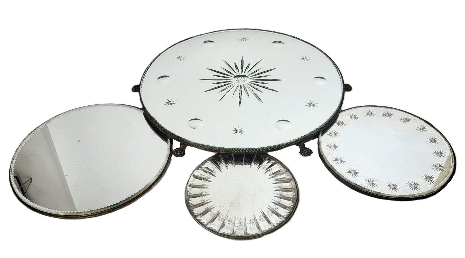 Four Victorian Mirrored Plateaus: Four mirrored Victorian mirror top plateaus, 19th century, comprising an etched mirror or plateau with mounting to reverse, an etched plateau with star design, a plateau with etched border, and a larg