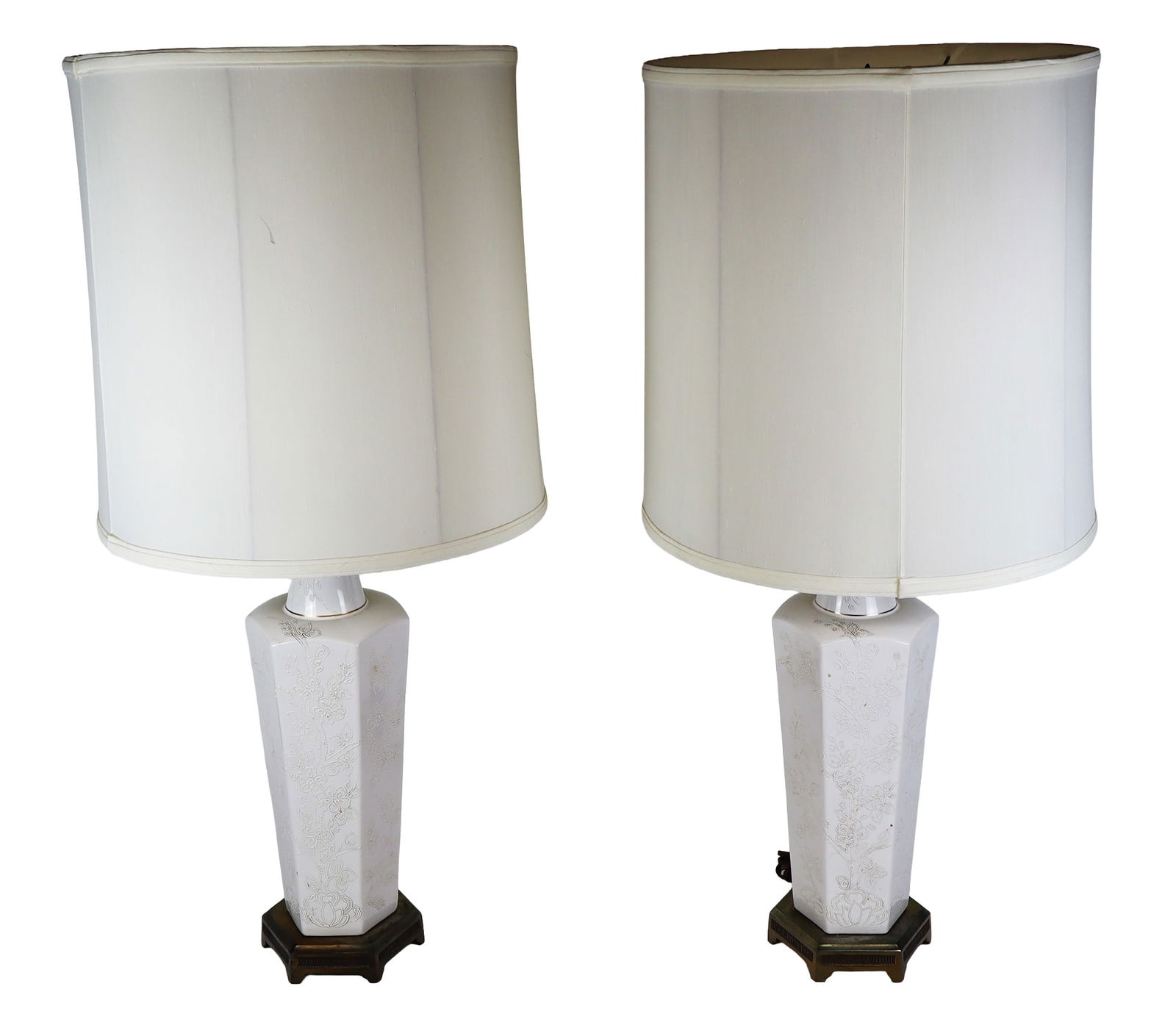 Pair of Blanc de Chine Vases Mounted as Lamps: Pair of blanc de chine and gilt decorated vases mounted as lamps, the rounded tops with gilt trim on square tapering vases decorated with line enamel leafy branch designs, on gilt metal bases. [Vases:
