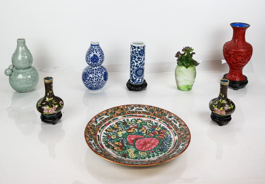 Assorted Chinese Decorative Articles, 8: Assorted Chinese articles, late 20th/21st century, comprising a celadon double gourd vessel, a blue and white transfer decorated double gourd vessel, a pair of cloisonne bud vases on carved wood