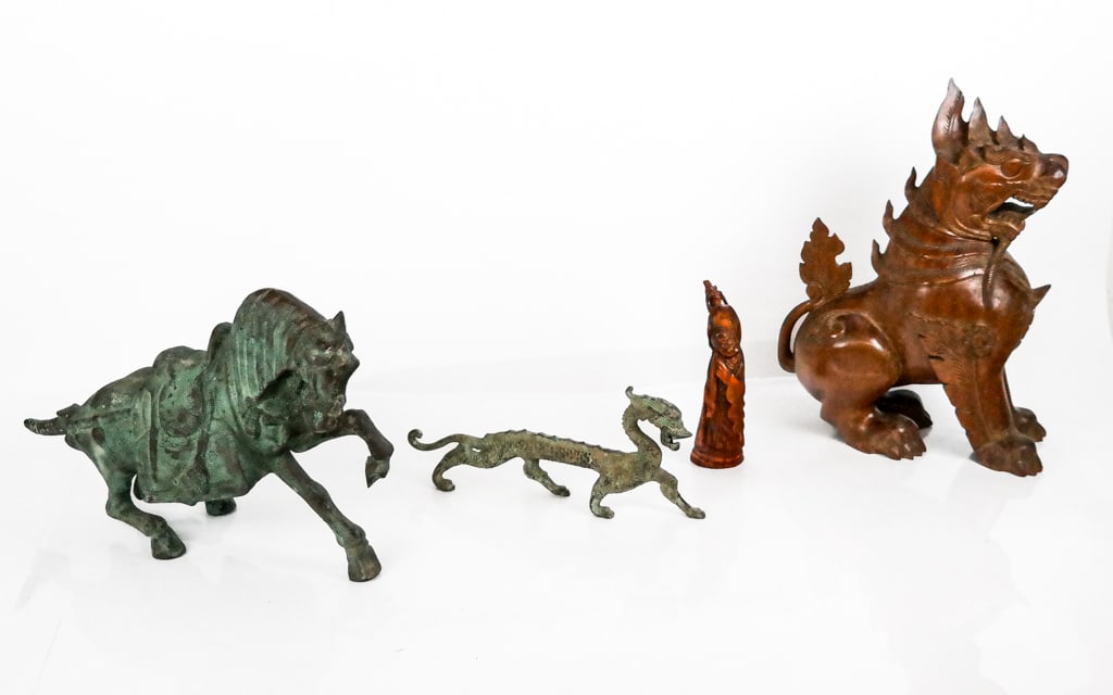 Chinese Archaistic Articles, 4: Four archaistic articles after the Chinese, 20th century, comprising a carved wood lion, a bonze sculpture of a horse after the Tang Dynasty, a cast iron statue of a dragon with faux patina finish, an