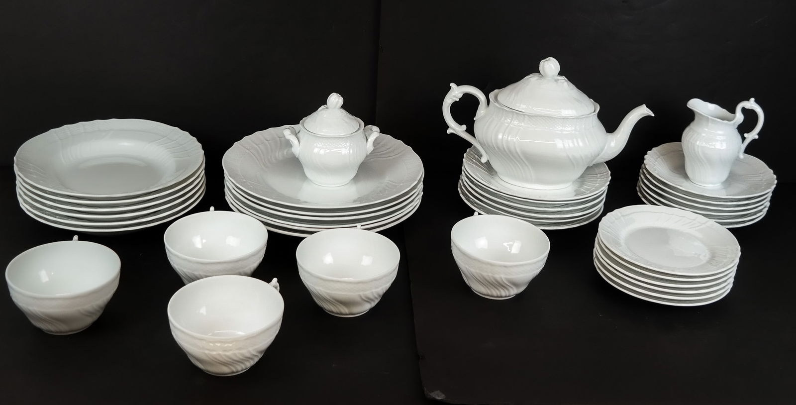 Richard Ginori "Vecchio White" Partial Service, 49: Richard Ginori "Vecchio White" partial porcelain service, Italy, 20th century, comprising a teapot, a covered sugar, a creamer, five teacups and six saucers, six salad plates, six dinner plates, six d
