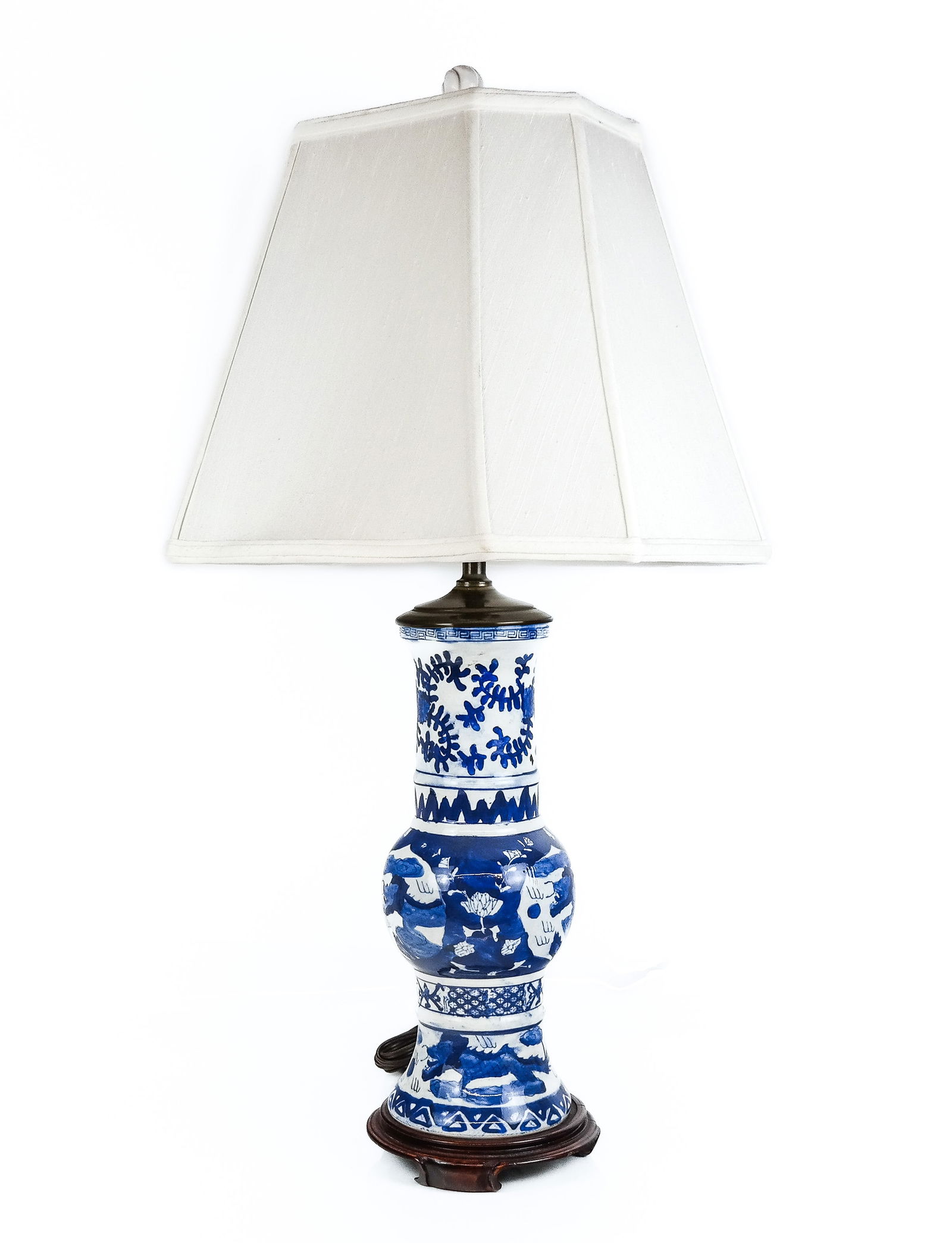 Chinese Blue and White Porcelain Table Lamp: Chinese blue and white porcelain beaker form vase mounted as a lamp, depicting stylized dragons amongst clouds and foliate designs with paneled shade and carved teakwood base. [Overall: 29" H x 12" W