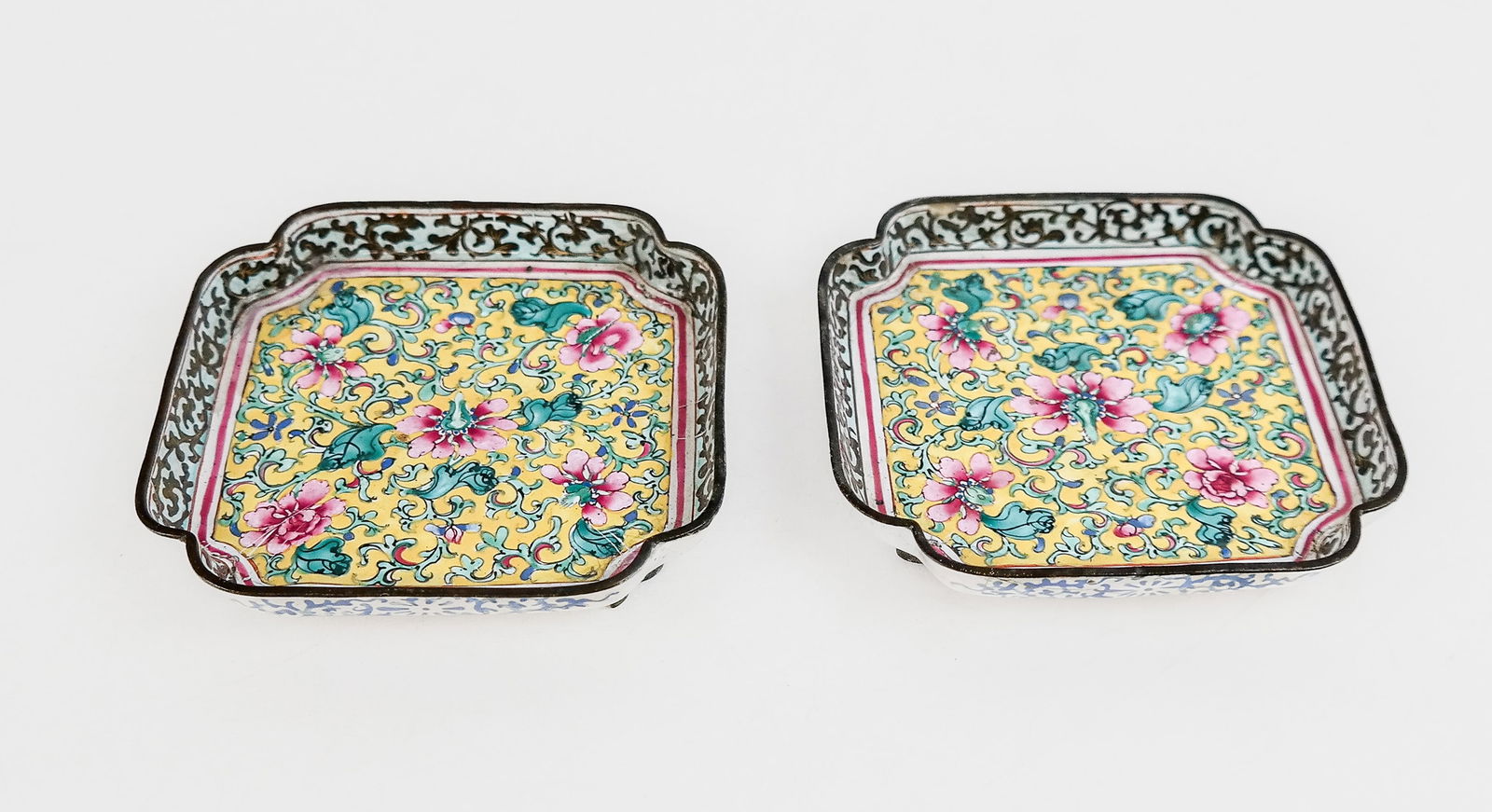 Chinese Pair Enameled Canton Ware Dishes: Pair of Chinese export Canton ware dishes, 19th century, with enamel foliate decoration over copper, on feet, each with a Chinese Arabic export mark to base. [0.75" H x 3.75" Square]. Condition is goo