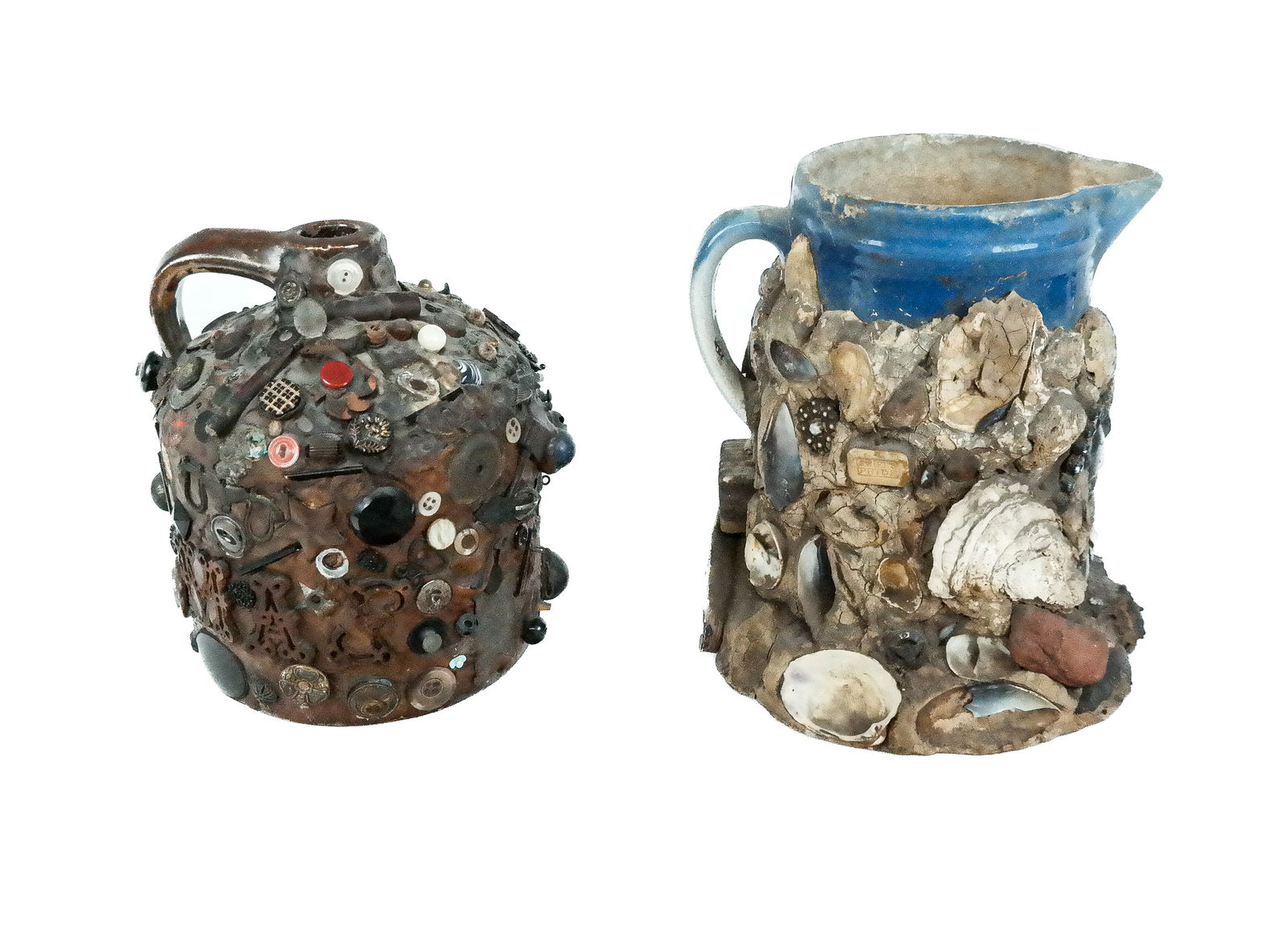 Two "Outside Art" Studio Pottery Memory Vessels: Two ceramic memory vessels, comprising a beach themed memory pitcher, the upper section simulating the sky with clouds, the lower three quarters encased with shells, metal badges, stones, and rocks [9