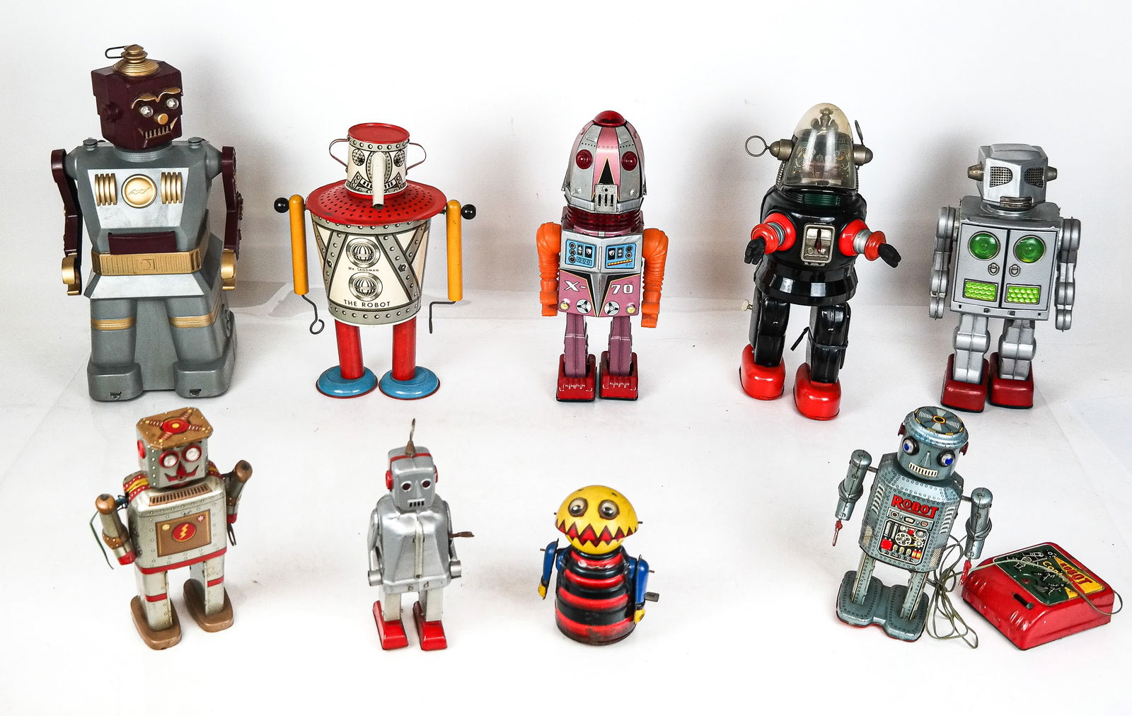 Group of Vintage Robot Toys, 9: Group of vintage robot toys, comprising a Wolverine Mr. Sandman robot [11.5" H x 8.5" W x 5" D], Marx plastic "Electric Robot and Son" with the "Son" [14.5" H x 7.25" W x 6" D], Linemar tin "R 35"