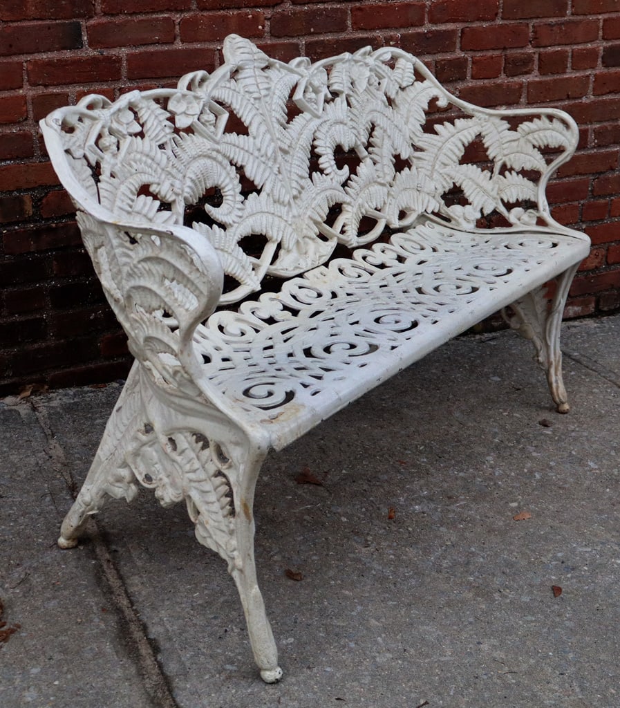 Coalbrookedale Manner Victorian Iron Garden Settee: Victorian Fern and blackberry pattern cast iron and white-painted garden settee, circa 1900, in the Coalbrookedale manner. [34" H x 54" W x 20" D; seat height: 17"]. Condition is good with
