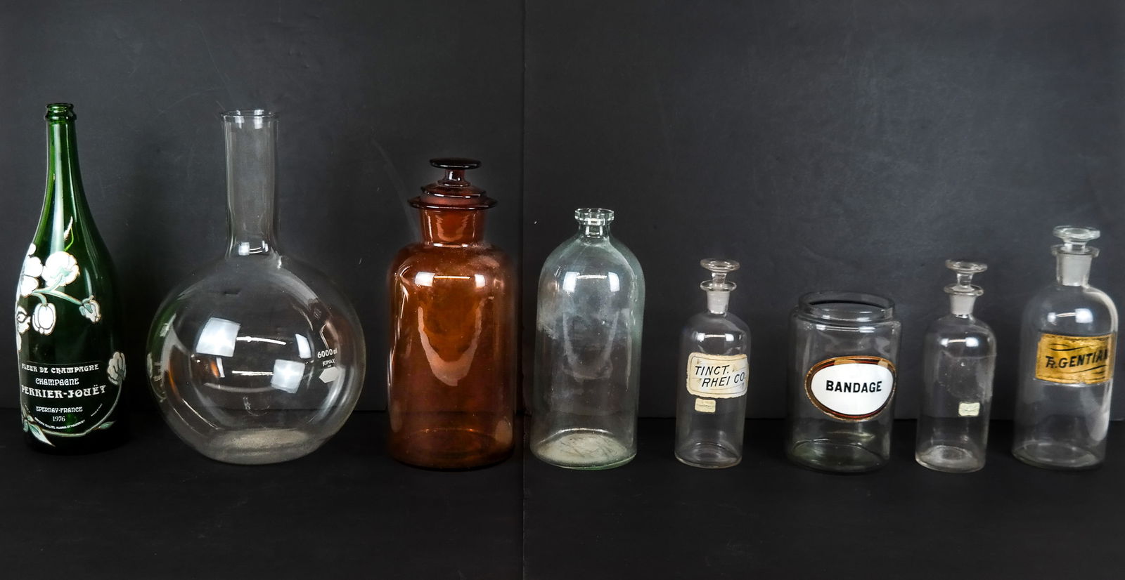 Assorted Glass Articles, 8: Assorted glass articles comprising medicinal articles a TR Gentian apothecary decanter, a Tinct. Rhei Co. decanter, an apothecary decanter with label missing, a cannister marked Bandage, a large