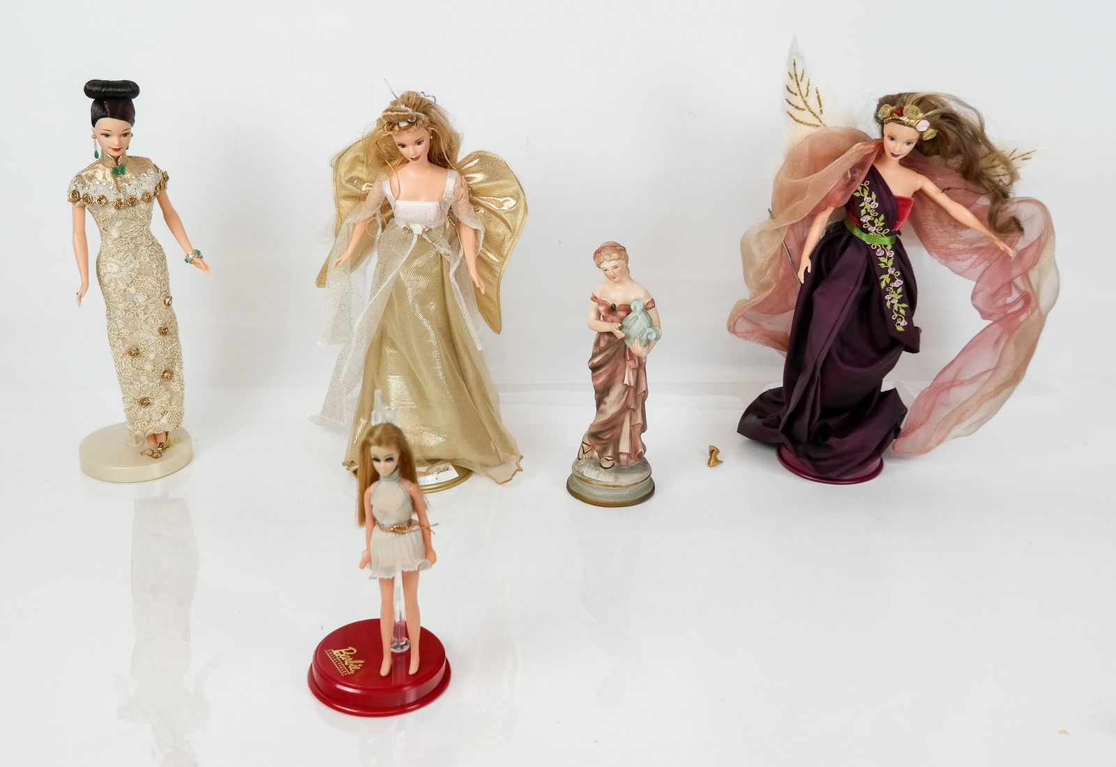 Group of Assorted Dolls, 5: Group of assorted dolls, comprising "Angelic Inspirations" Barbie, unboxed, "Gold QiPao" Barbie, unboxed, Angels of Music Collection "Heartstring Angel Doll", unboxed, and 2 miscellaneous dolls.