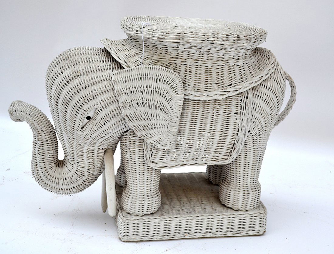 Vintage Wicker Elephant Form Side Table: Bears raised trunk and oval top. [11" W x 28" D x 19 1/2" H]. Wear consistent with age and use.