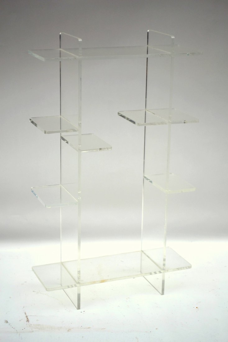 Lucite Etagere: Four-tier lucite etagere. [25" x 42" H x 8 3/4" D]