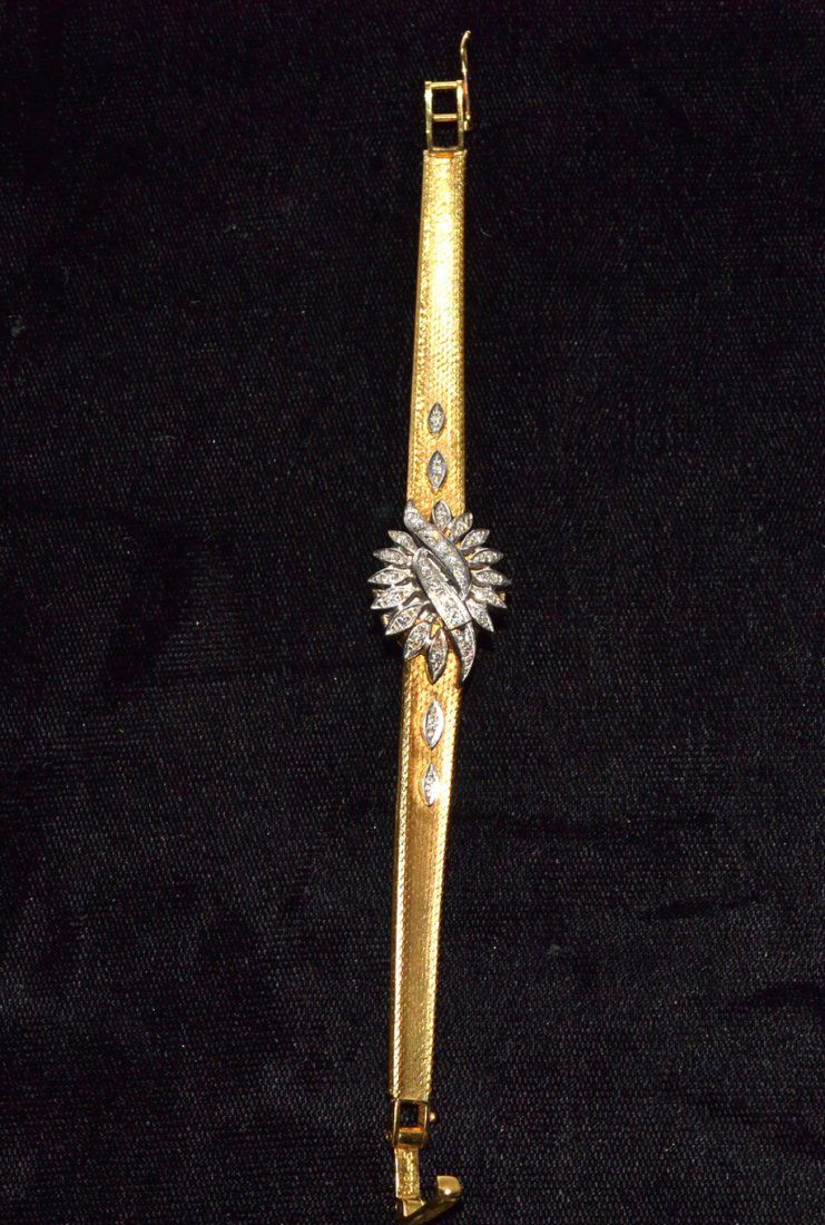 18k Yellow Gold Ladies Watch with Diamond Cover: Round white dial with "L.V. Chopard Geneve" in black letters on face [15m dia.]. Cover contains 12 round brilliant cut diamonds [approximately .25 ct total], 14 round single cut diamonds [approximatel