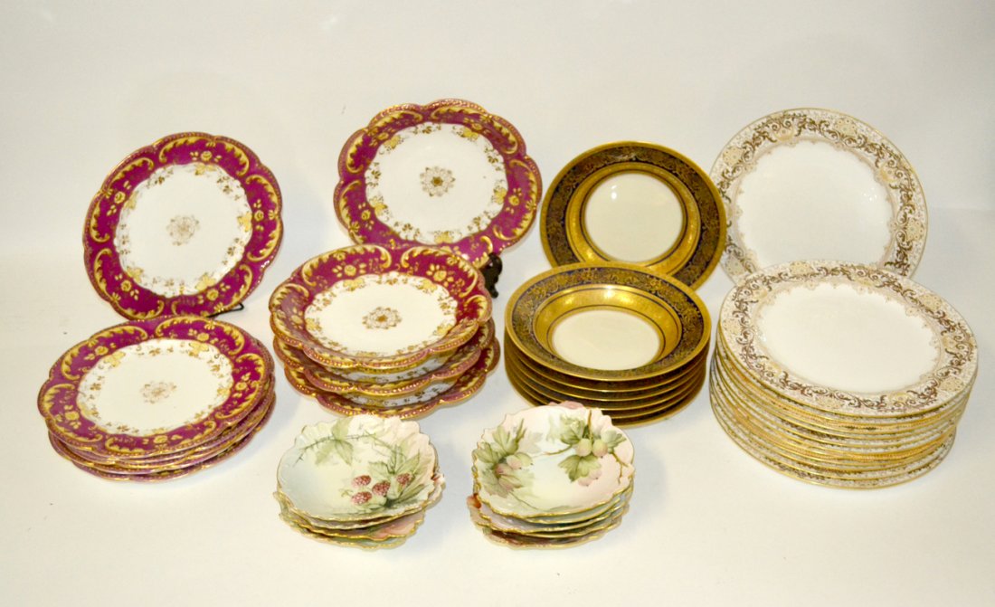 Partial French and English Porcelain Services: 38 Items. Comprises: 7 deluxe porcelain soup bowls with gilt bands and scrolling motif against a cobalt background; 12 Doulton Burslem dinner plates with elaborate gilt enamel border; 9 hand painted b