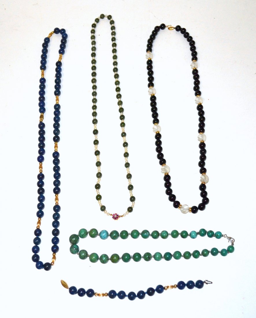 Four Necklaces and One Bracelet: Comprises: 1.) Sodalite and lapis bead necklace with uniform beads [10mm Dia.] interspersed with smooth fluted gold beads. 2.) Sodalite bead bracelet with uniform beads [10mm Dia.]. 3.) Black onyx and