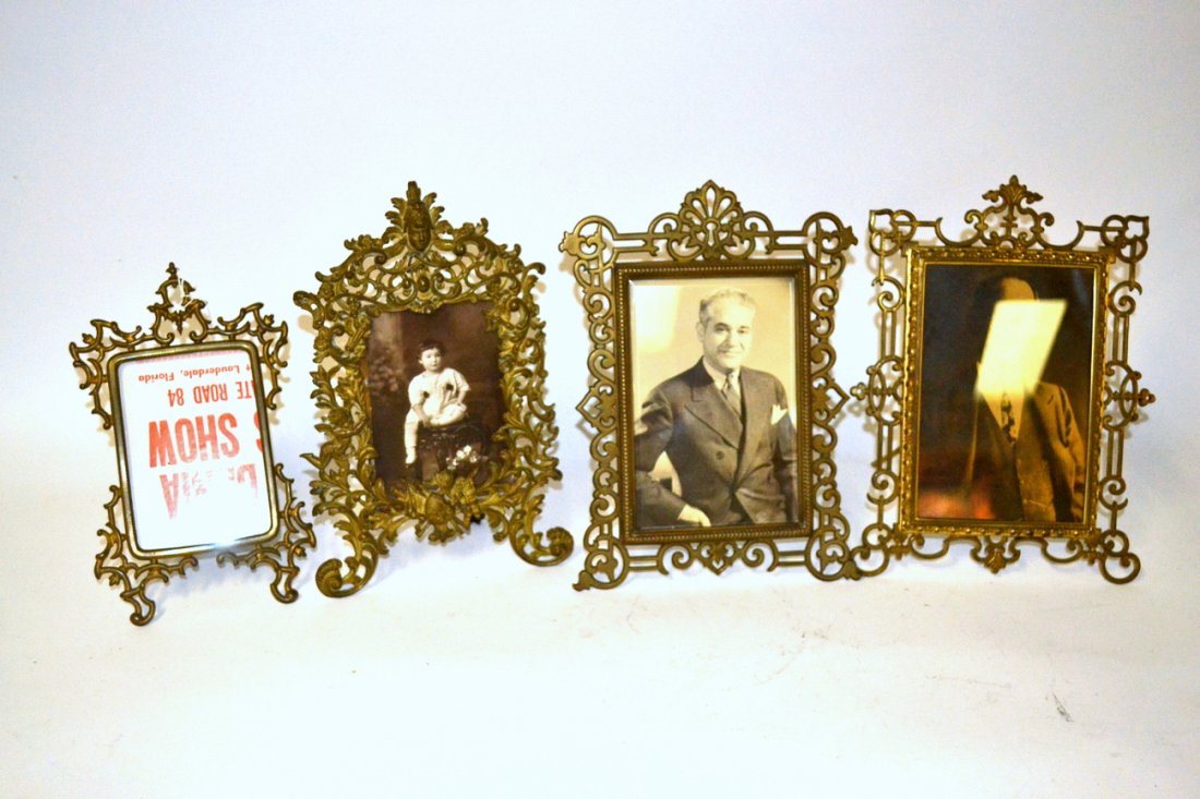 Four Vintage and Antique Bronze Picture Frames: Comprises: 1). Pierced surround with egg and dart. Frame [12" x 9"]. 2). Pierced surround with acanthus pediment [12" x 8 1/8"]. 3). Pierced surround leafy elements and neo-classical mask pediment [11