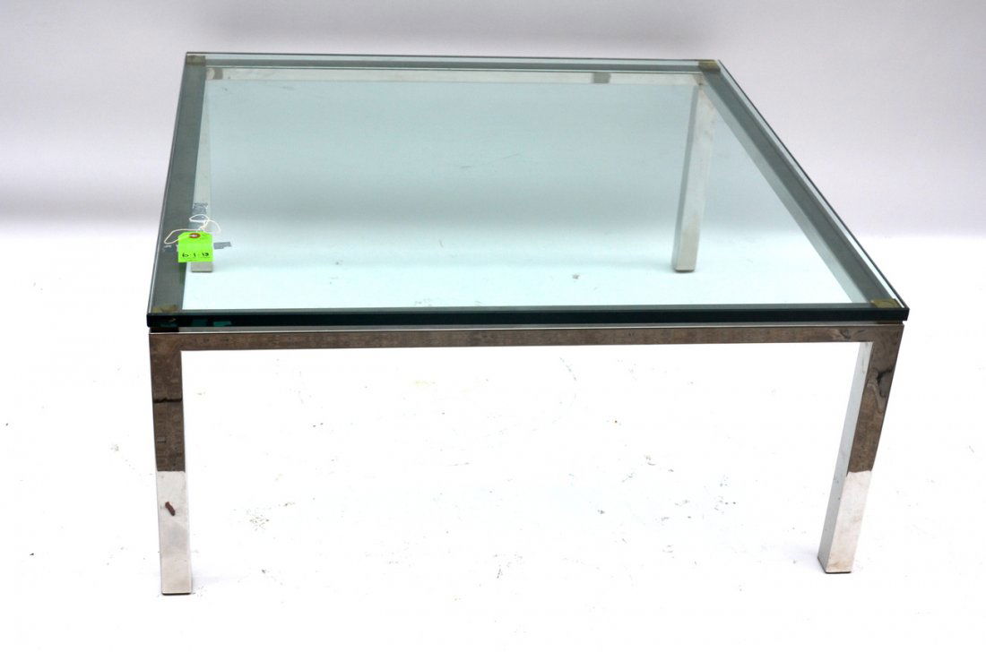 Modern Glass Top Cocktail Table: Chrome table with brass accents above each leg. Bears a green tinted glass top. 36" sq. x 16 1/4" H. In good condition.