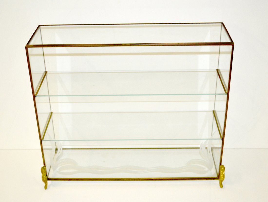 Table Top, Brass & Glass Vitrine: Three-tier vitrine. Enclosed on three sides with open back, bears brass seahorse front feet and etched glass accents. 16 5/8" w x 5 3/4" d x 14" h. Light wear.
